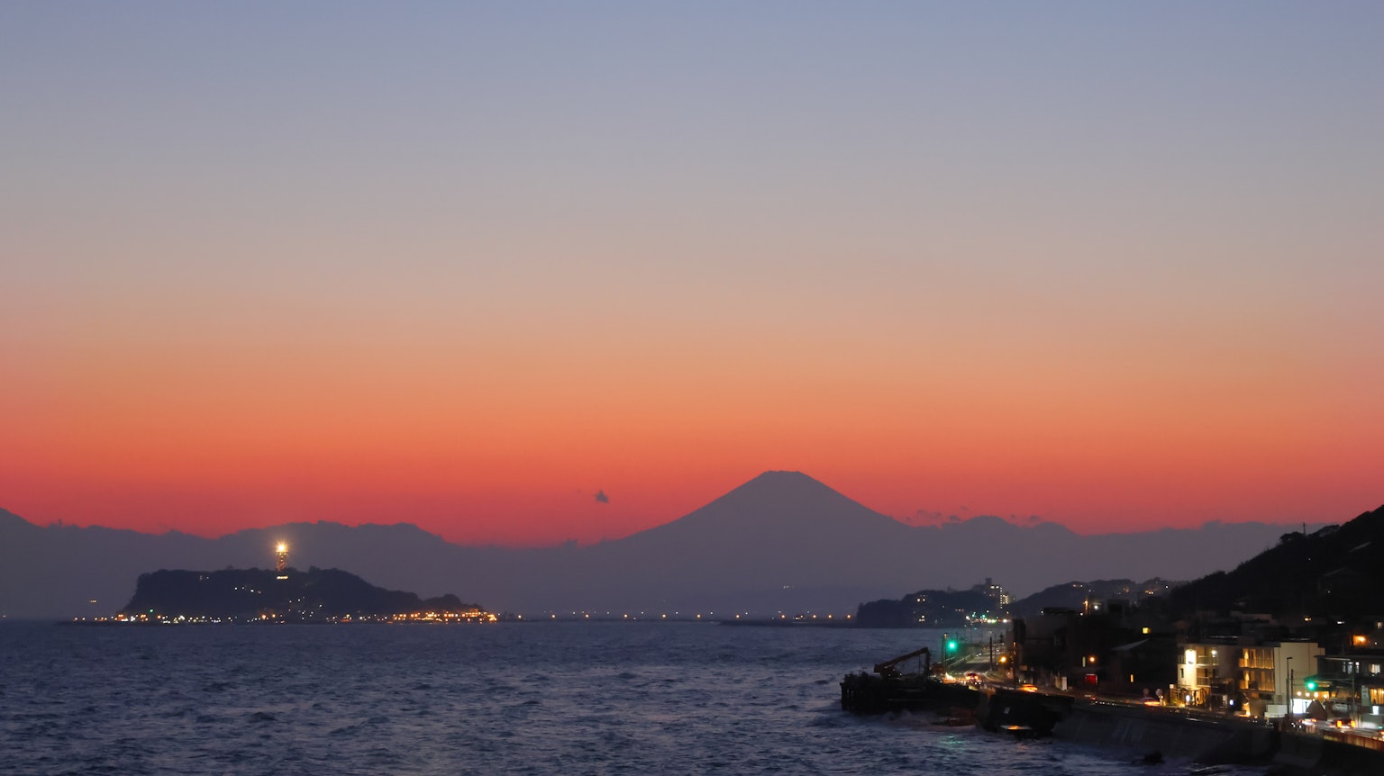 富士山在海岸线上的多彩日落背景下的风景