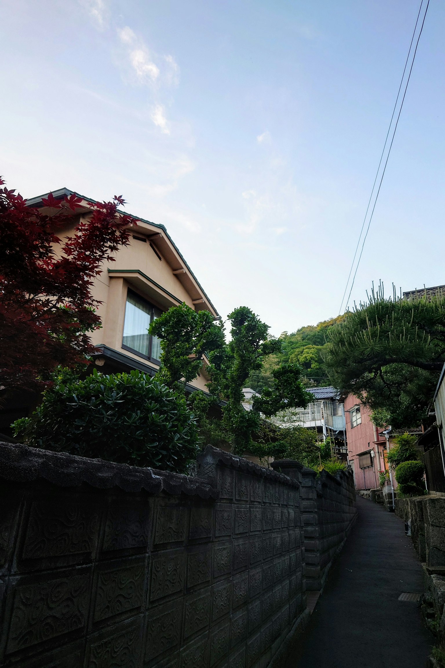 Narrow street lined with houses and blue sky
