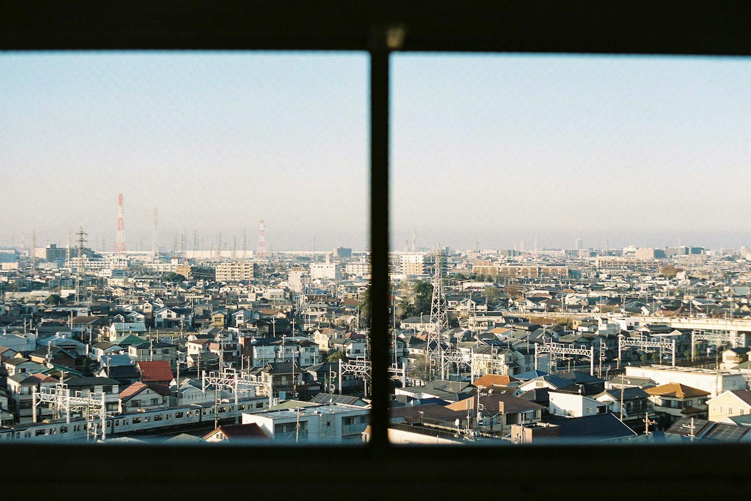 View of Tokyo skyline and clear blue sky through a window