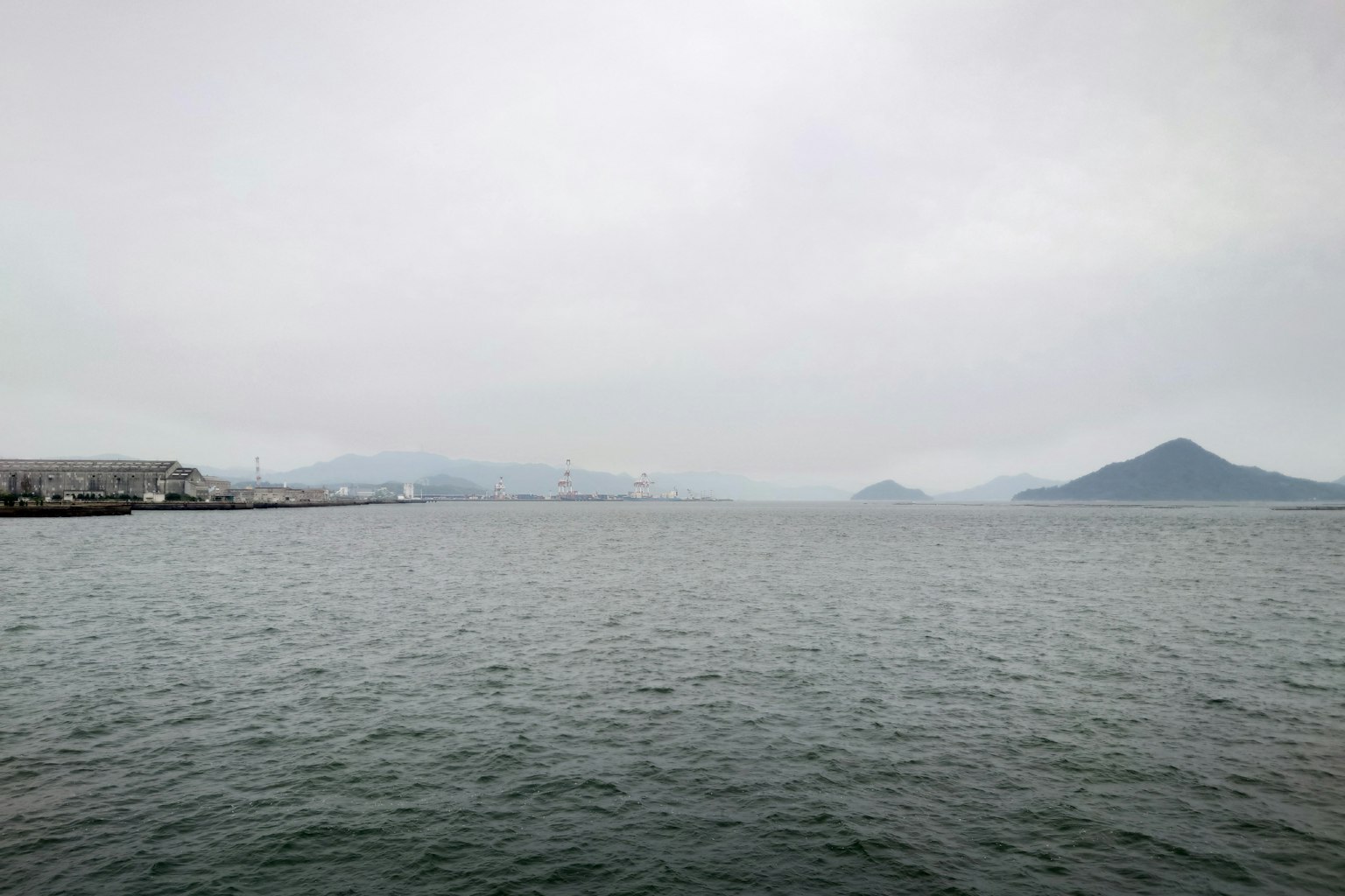 View of the sea with misty mountains