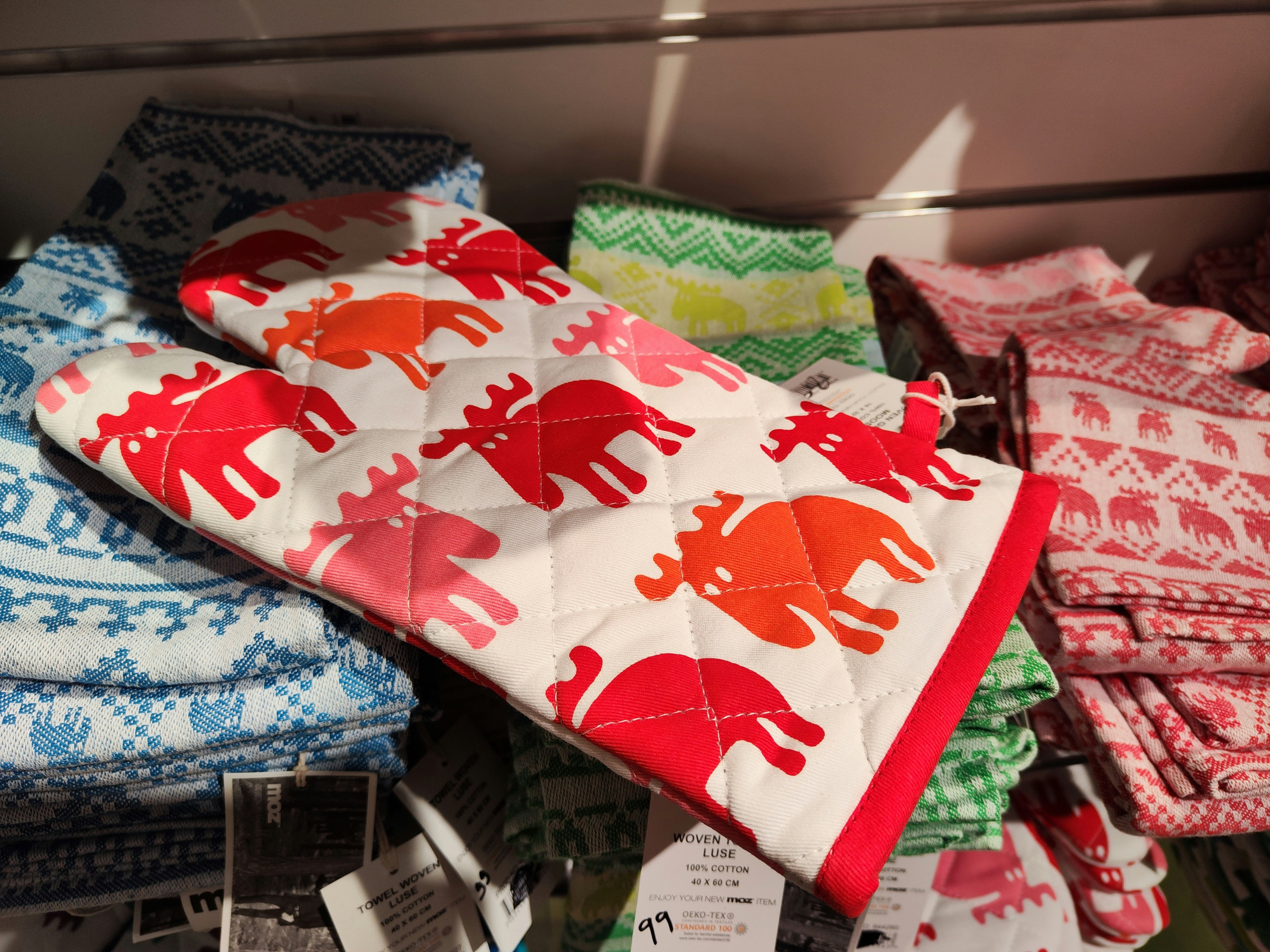 Stacked animal-pattern cushion covers on a bed in an indoor room