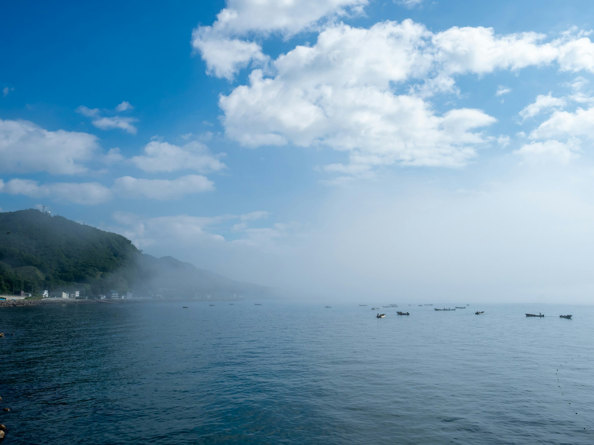 霧のかかった海と遠くの島影、空に広がる雲