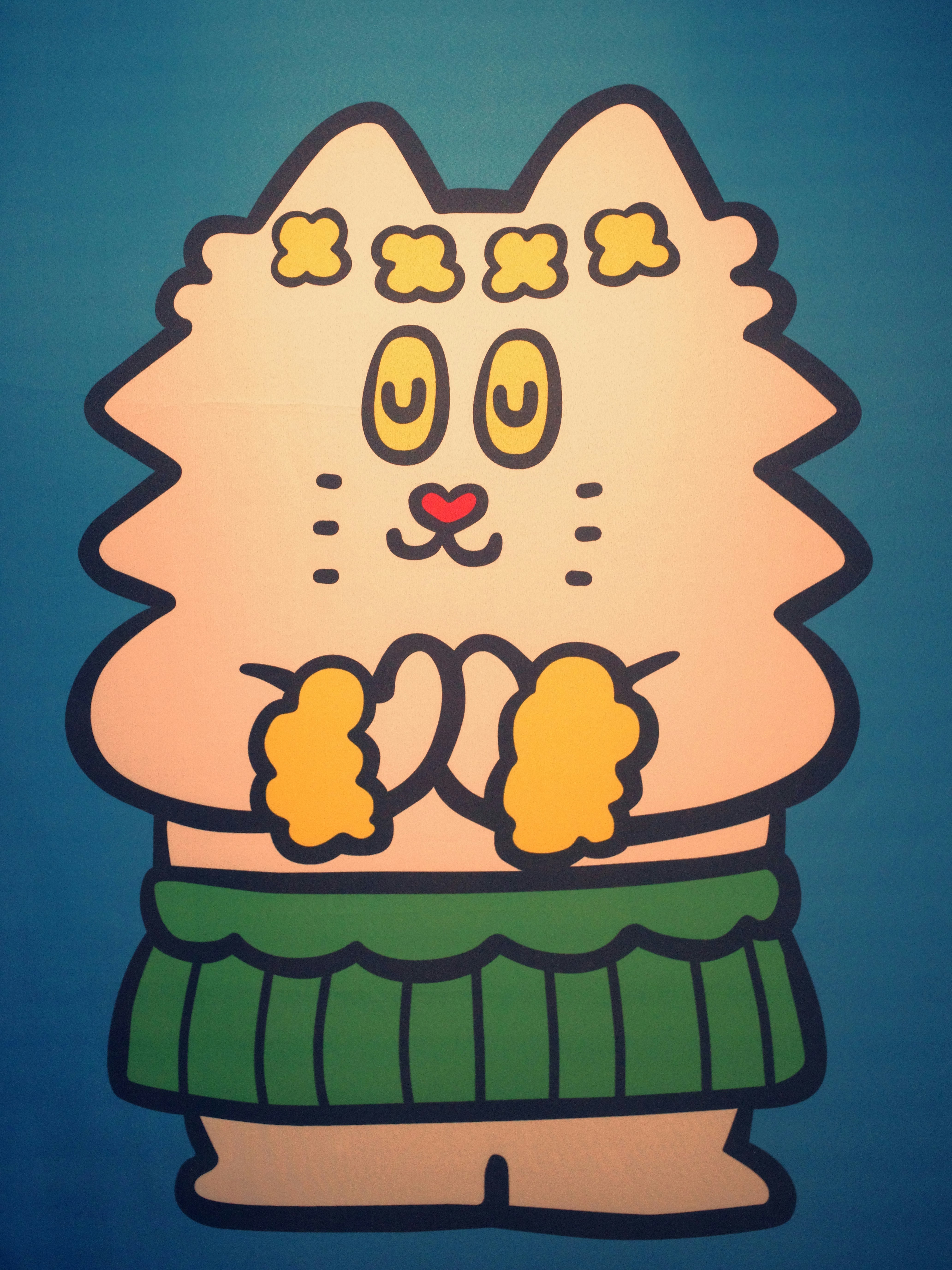 青い背景の上に描かれたニット帽のかわいい猫のイラスト