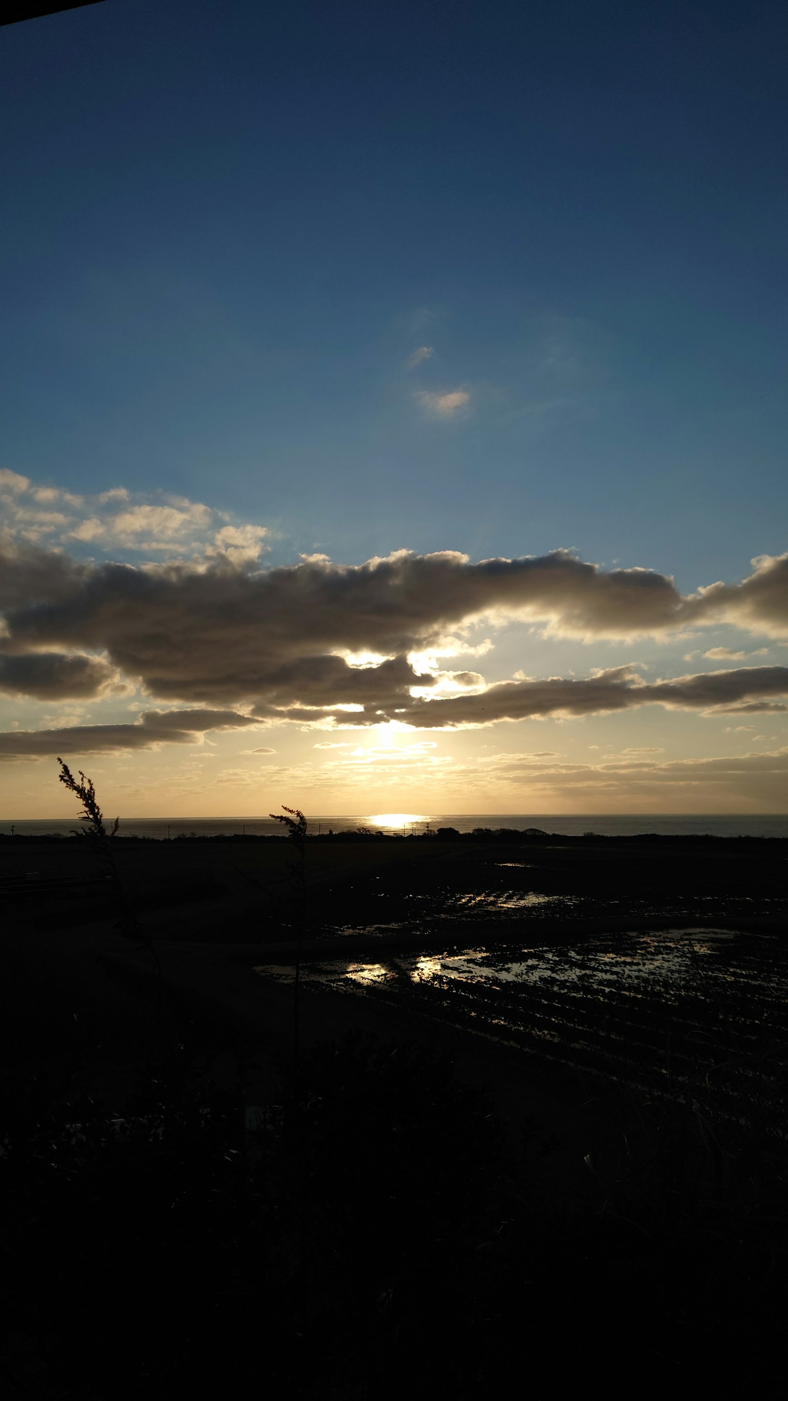 Beautiful sunset visible through clouds over the sea