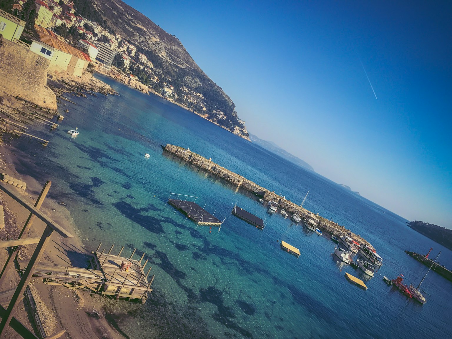 Scenic view of a harbor with small boats and clear blue water