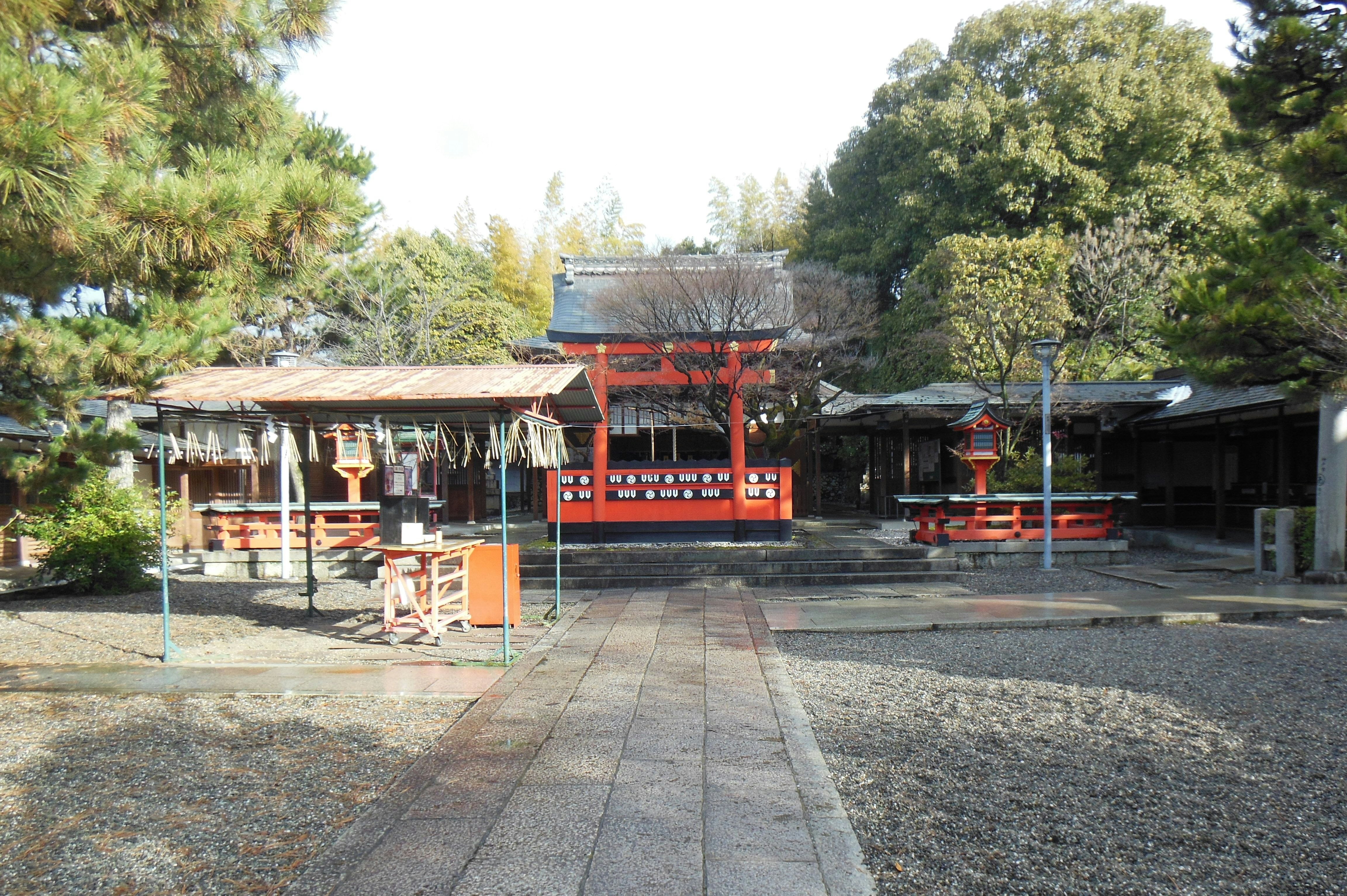Shinto shrine courtyard with torii gate and purification fountain