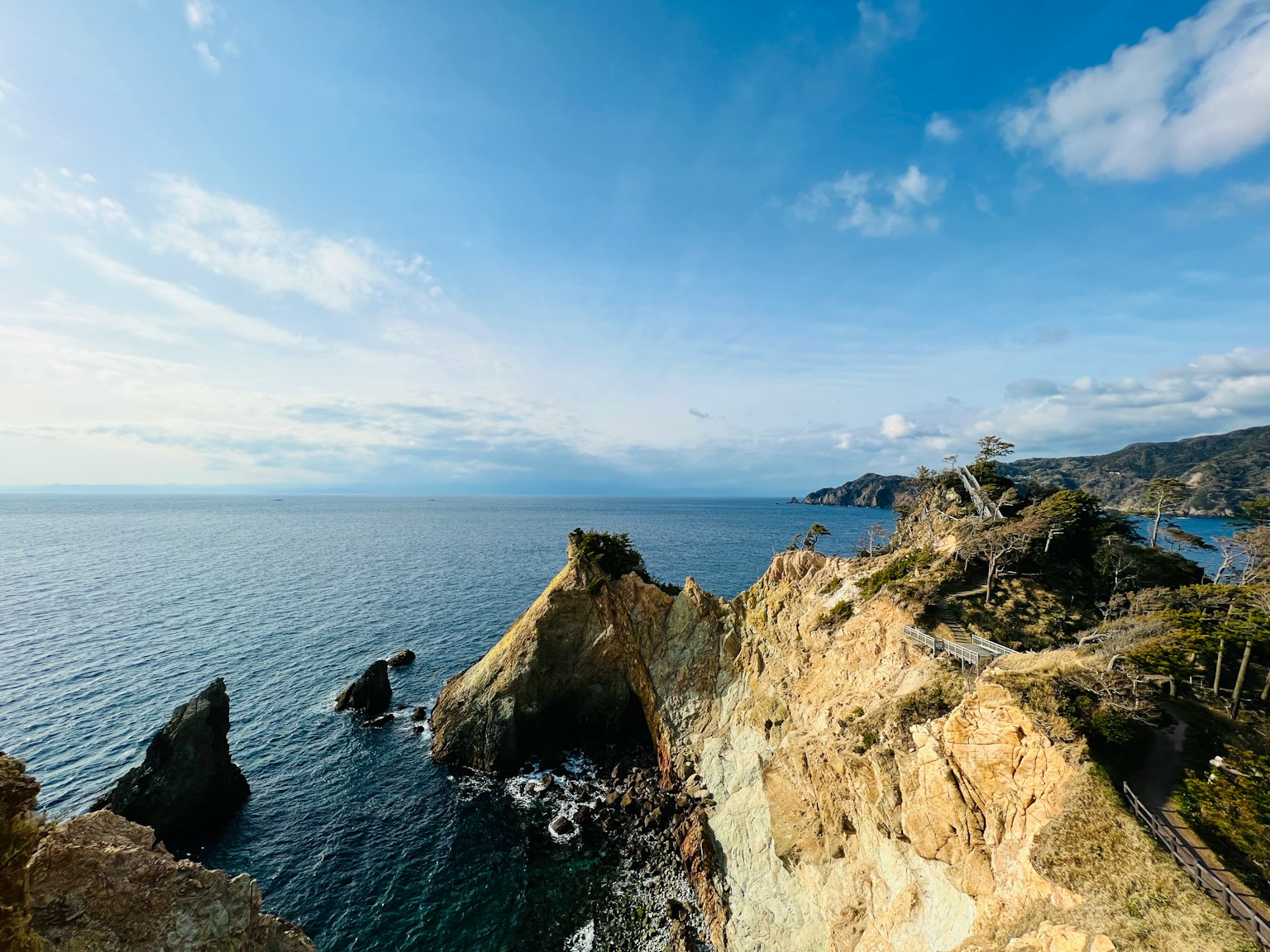 Vista panoramica delle scogliere che si affacciano sull'oceano e cielo blu