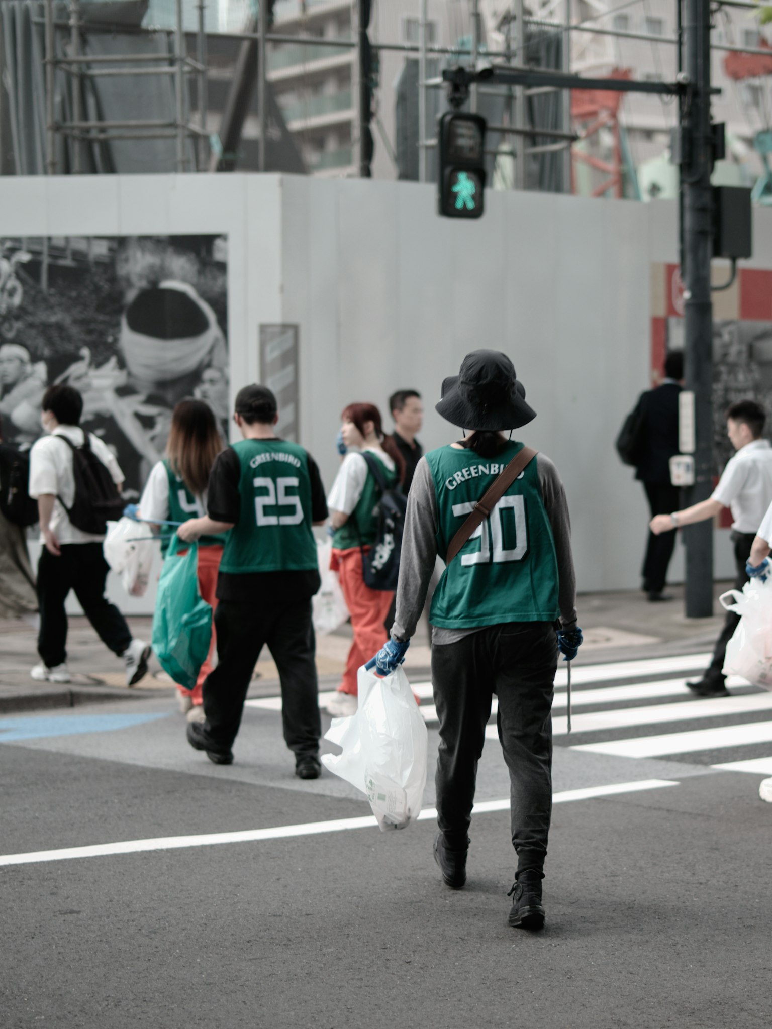 Group of people crossing the street carrying bags