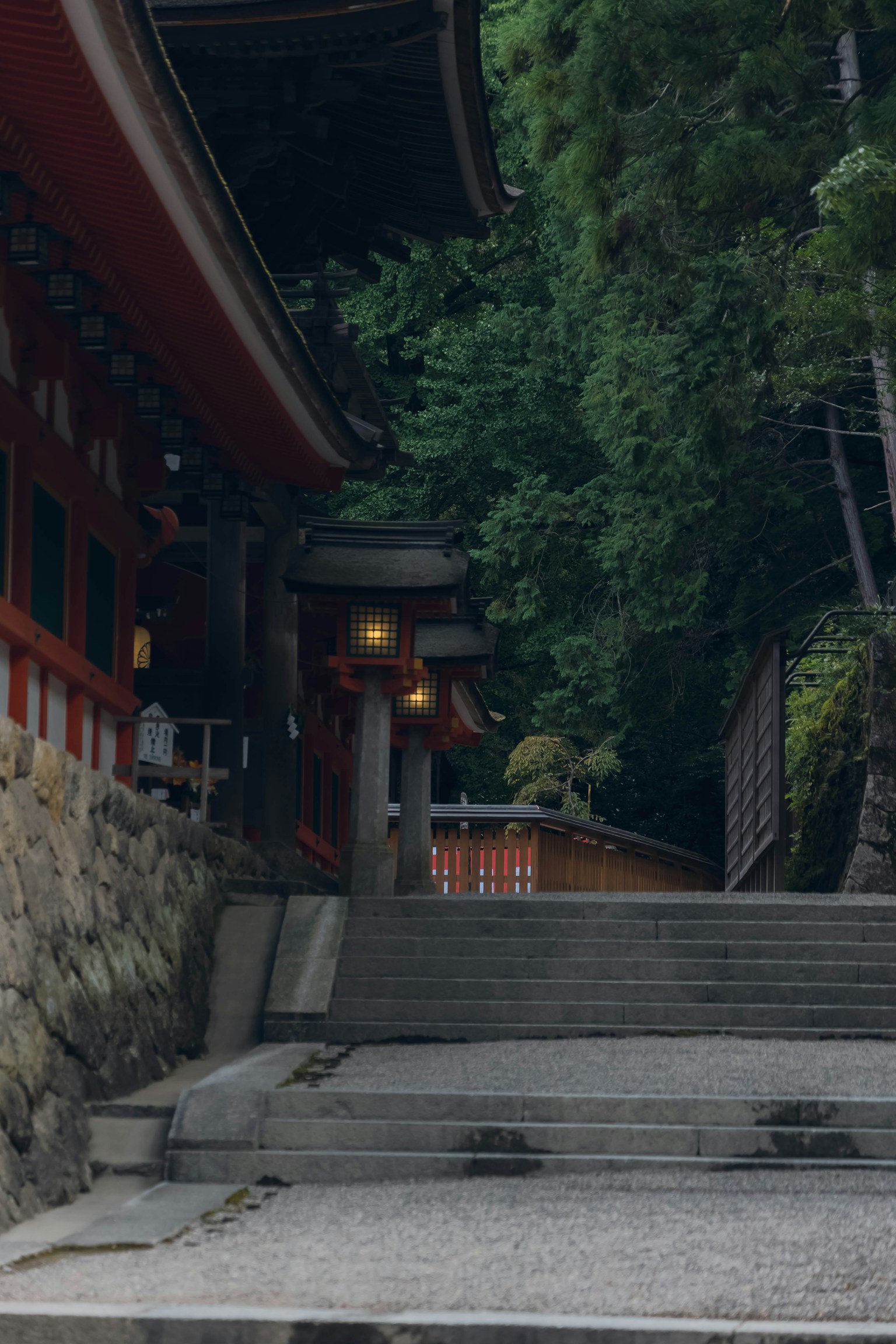 Stone steps leading to a shrine surrounded by lush greenery