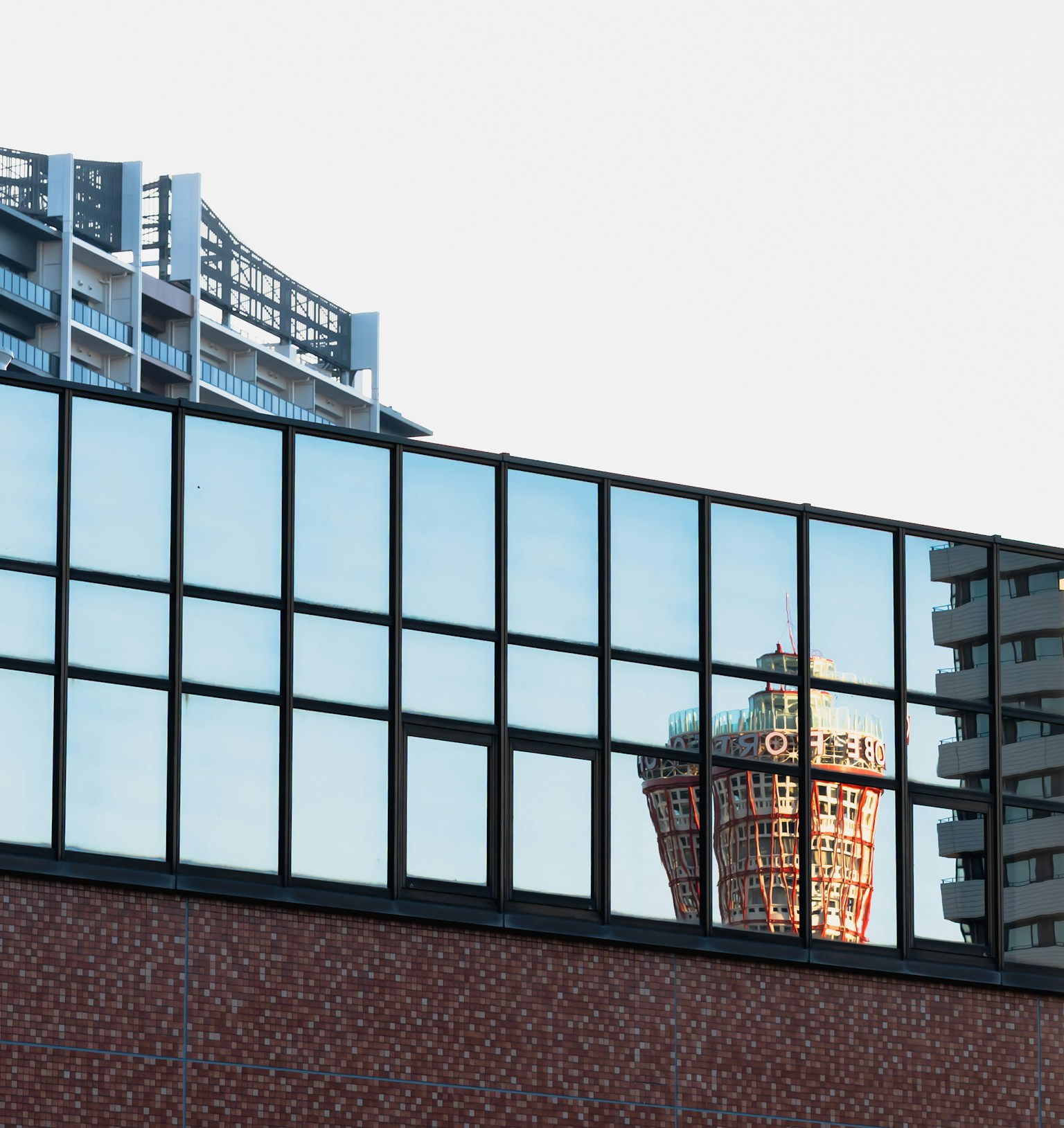 Reflection of a skyscraper on a glass wall with modern architectural design