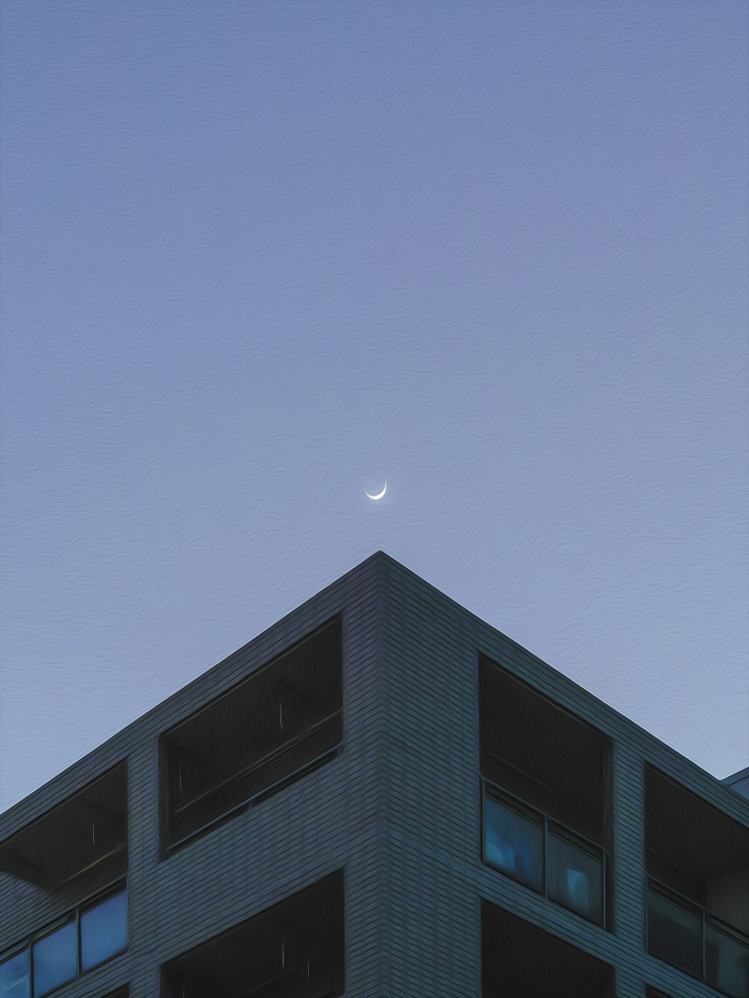 現代建築上方可見月亮和清澈的藍天