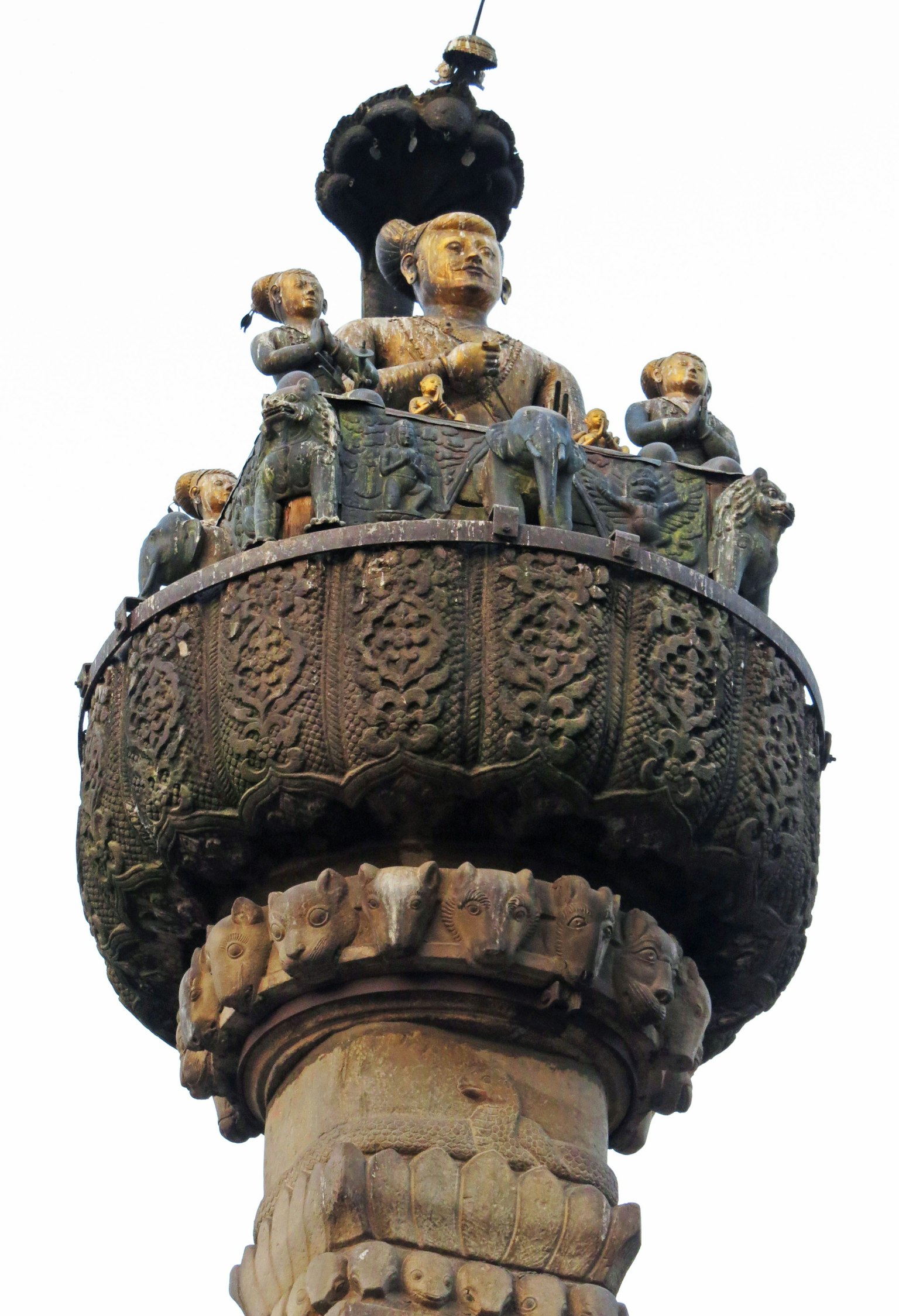 Sculpture of a seated figure with children on a decorative column