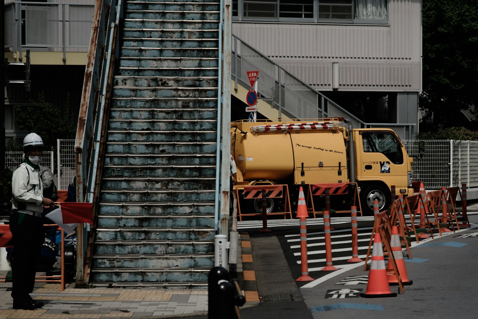 Construction site featuring a staircase and a yellow truck