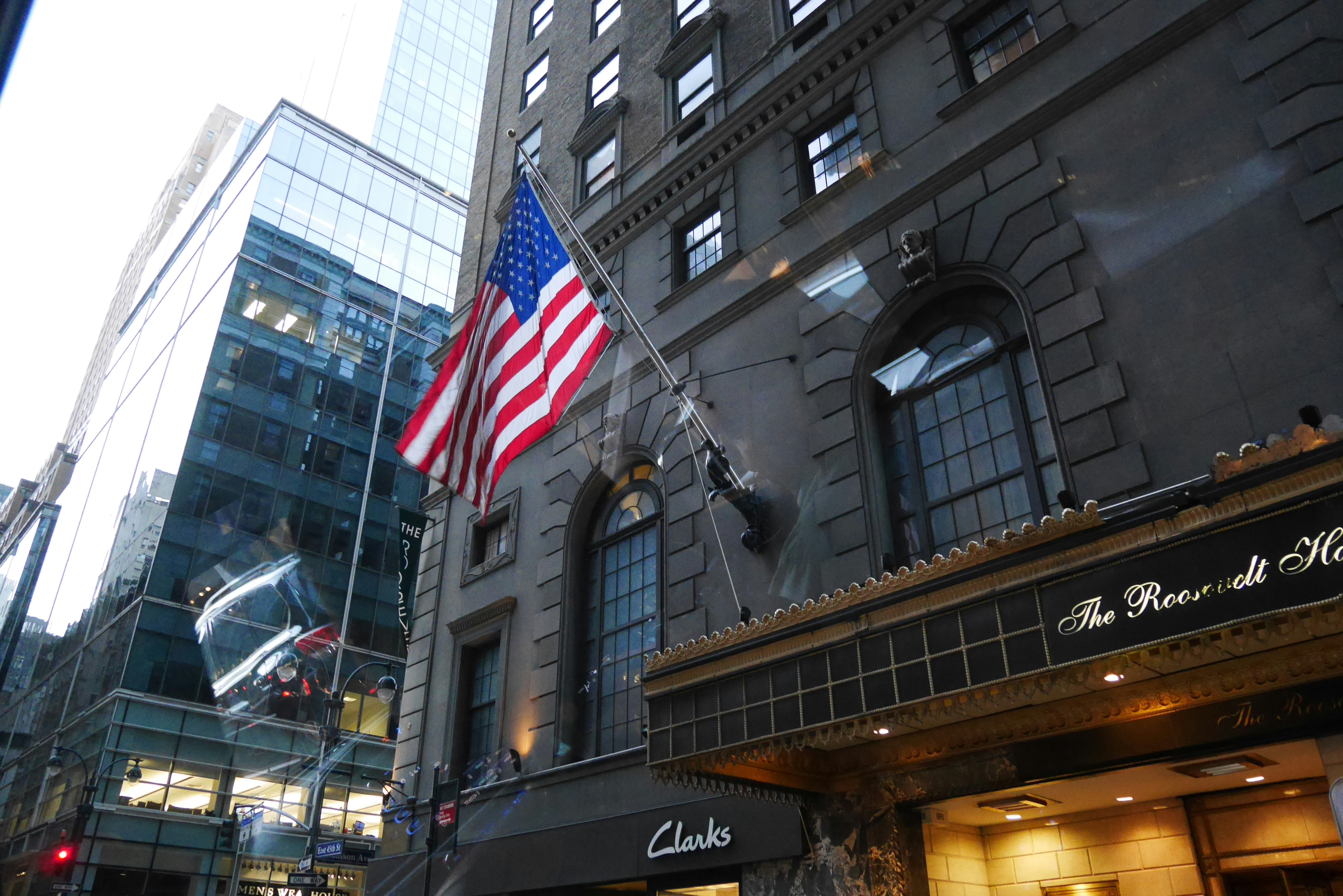 American flag in front of a brick building exterior