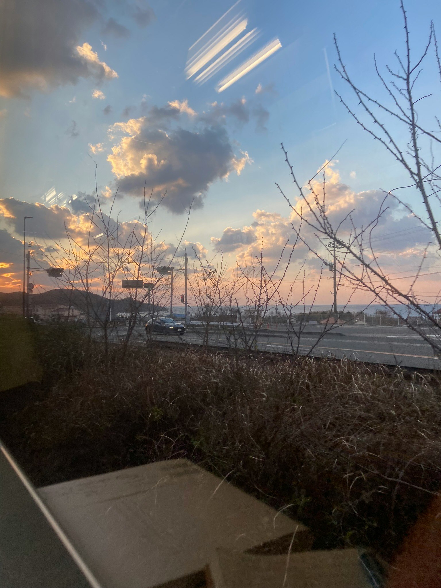 通过窗户可见的夕阳天空与云朵