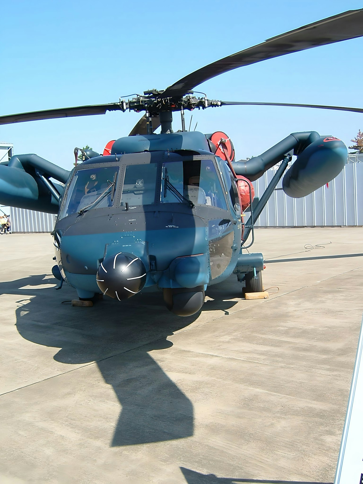 Front view of a blue helicopter featuring large rotors and distinctive design