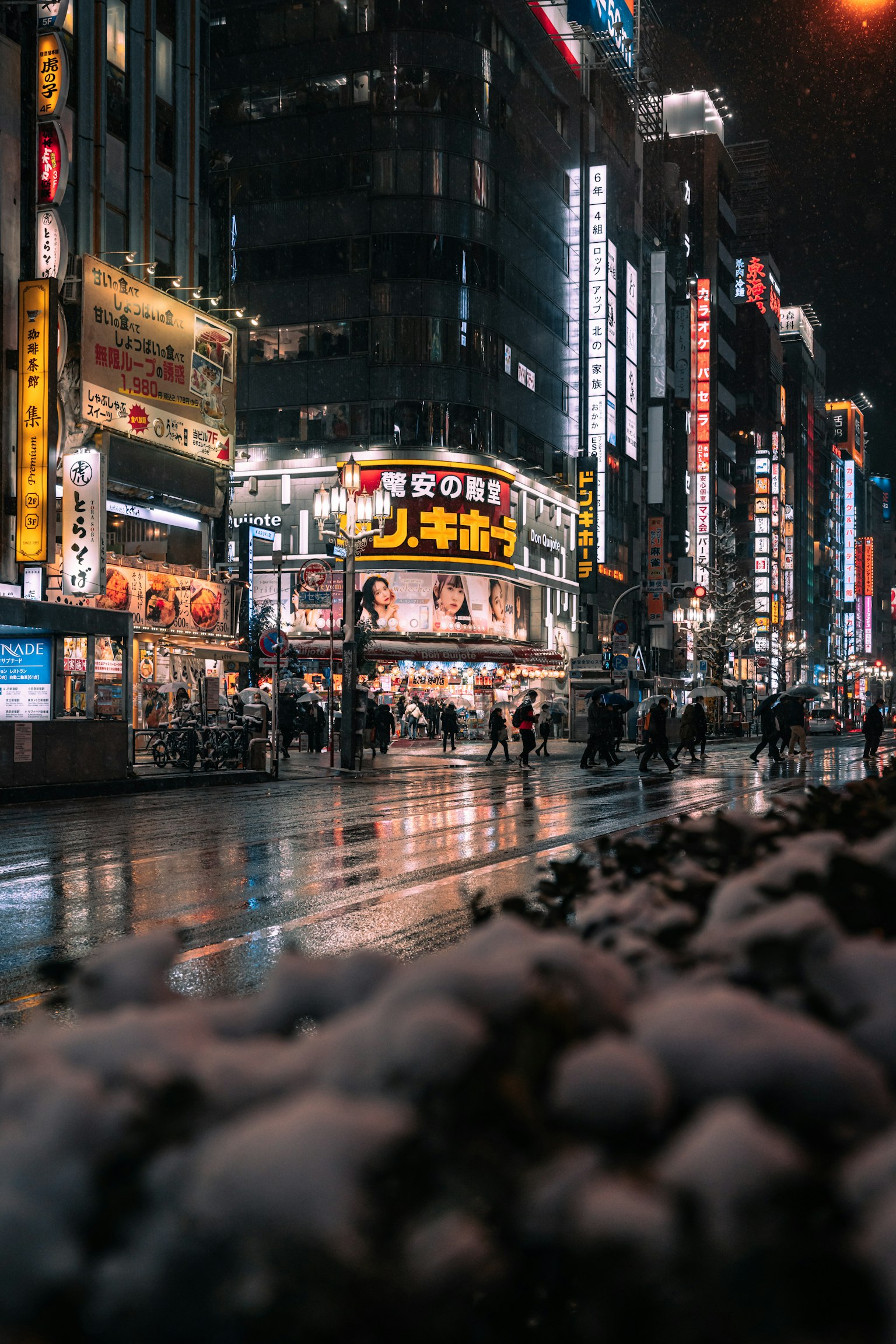 Night cityscape with vibrant neon signs and wet streets
