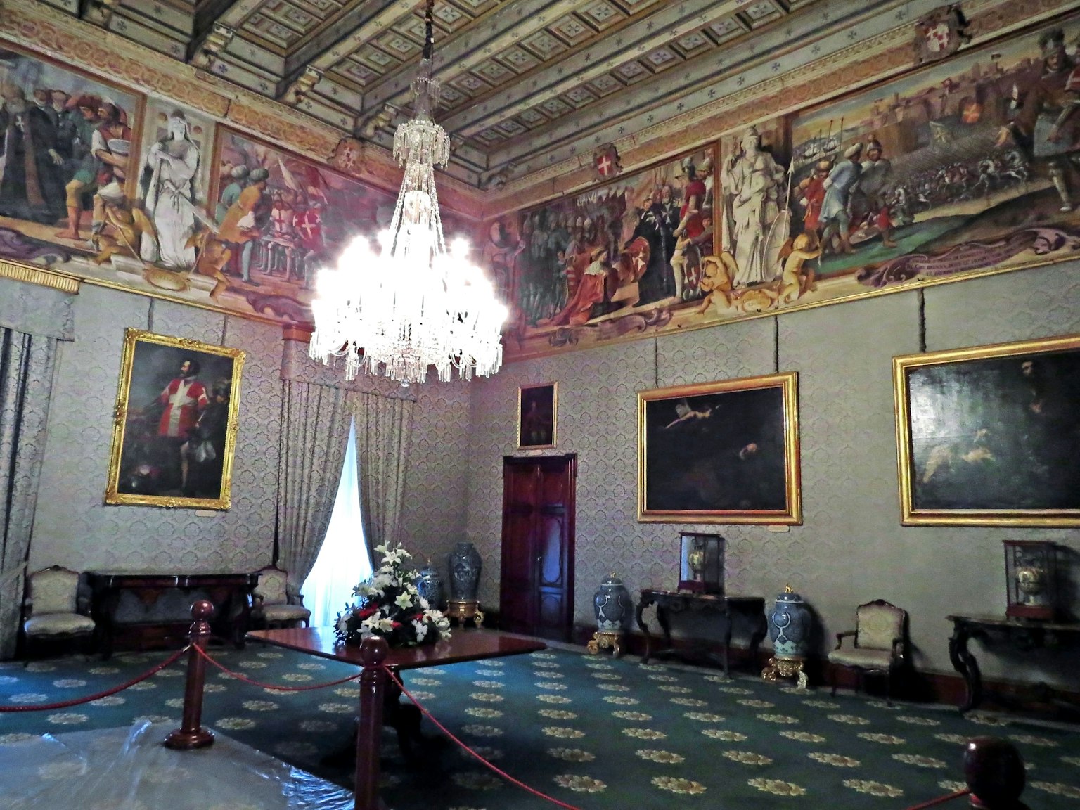Elegant art room with a chandelier historical paintings on the walls