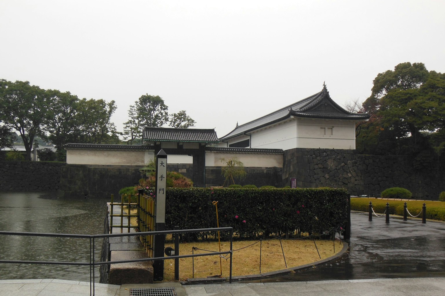Exterior view of the Imperial Palace in Tokyo with rain and garden