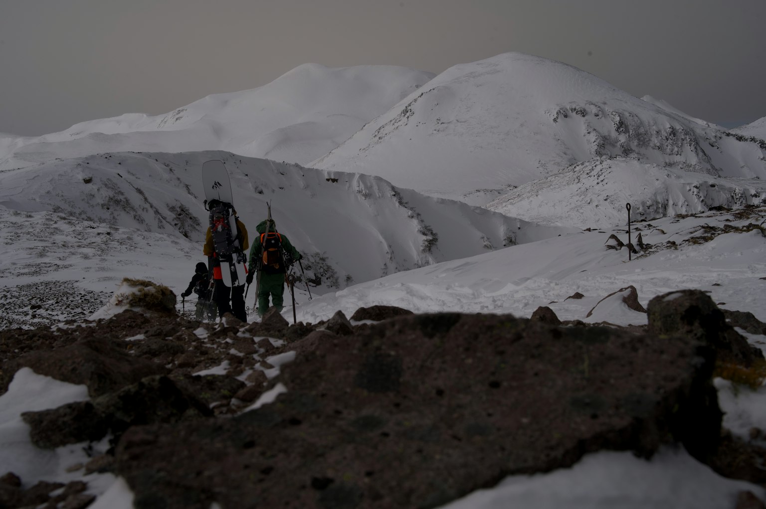 Randonneurs marchant dans un paysage montagneux enneigé