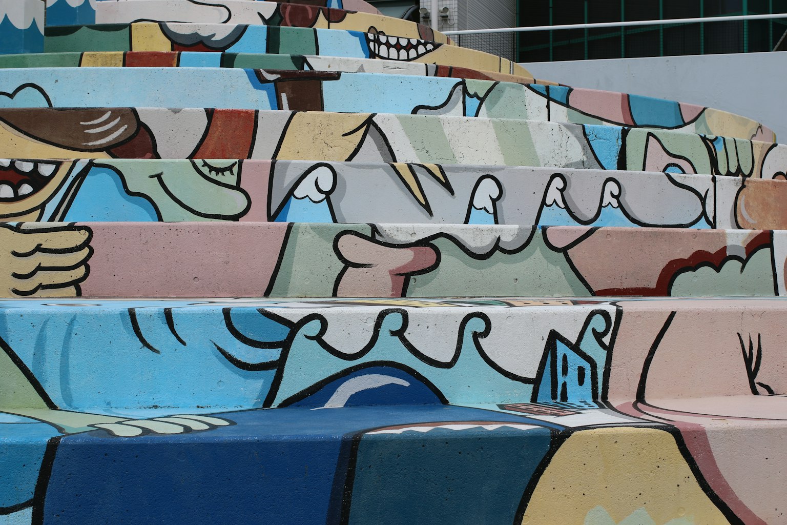 Colorful artwork on steps featuring playful characters and waves