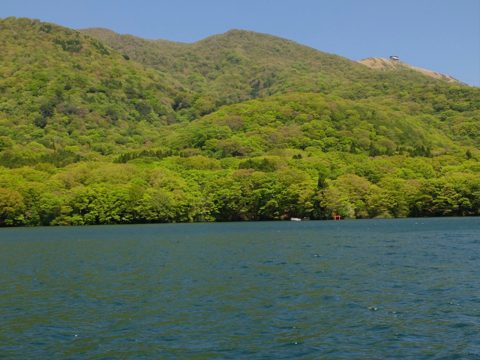 Lush green mountains with calm water surface