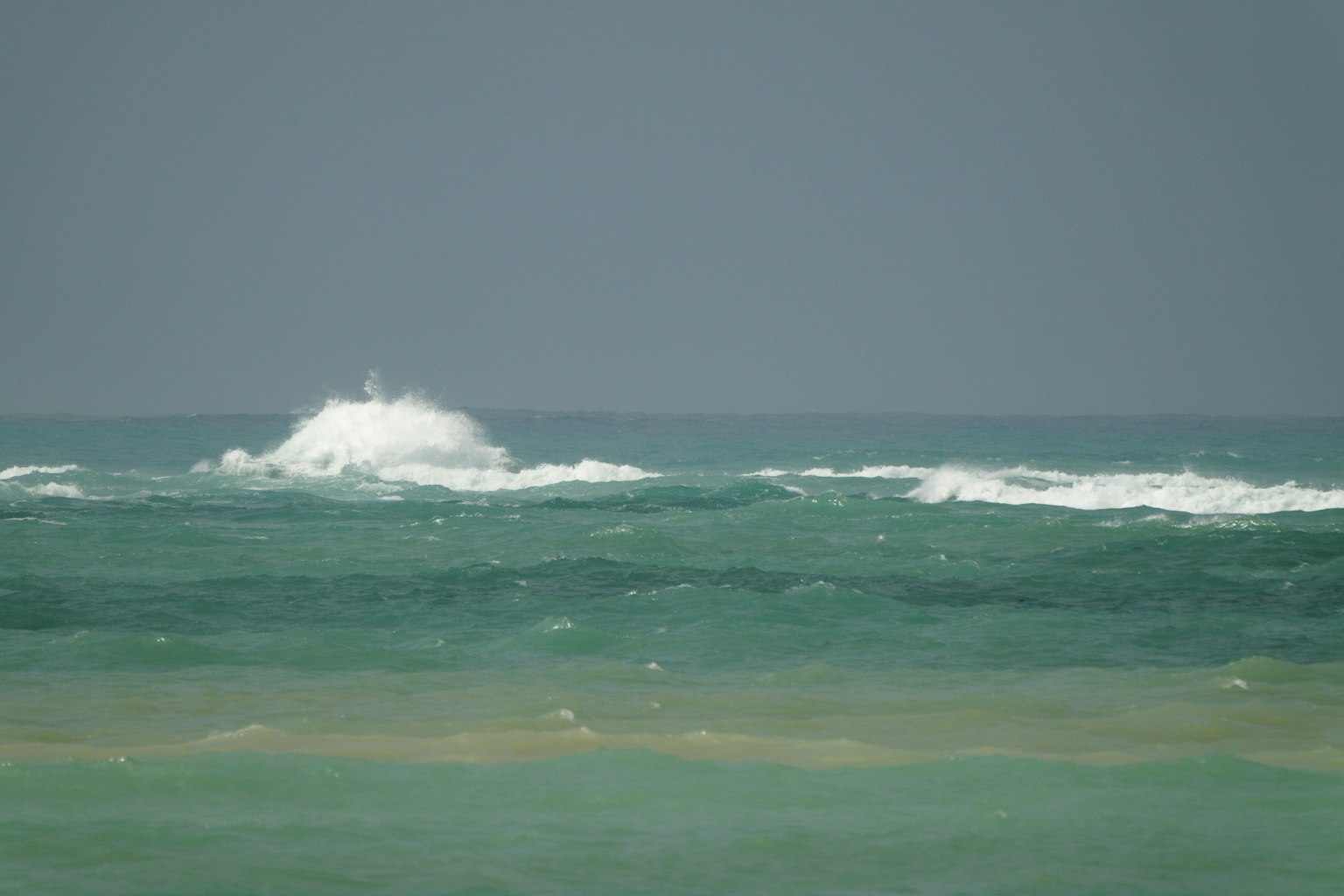 Scenic view of blue ocean with white waves