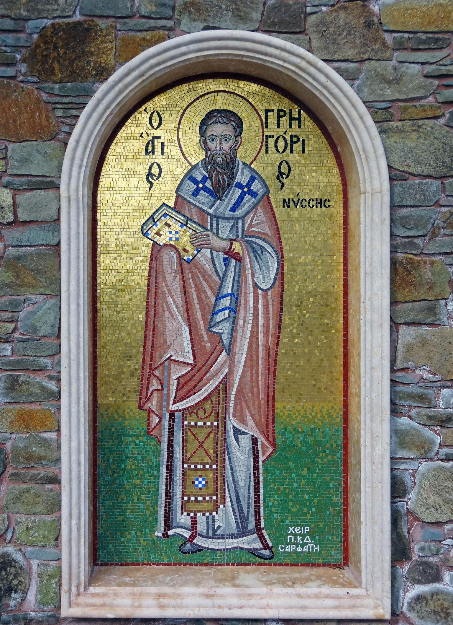 Mosaic icon of a saint standing with a golden background