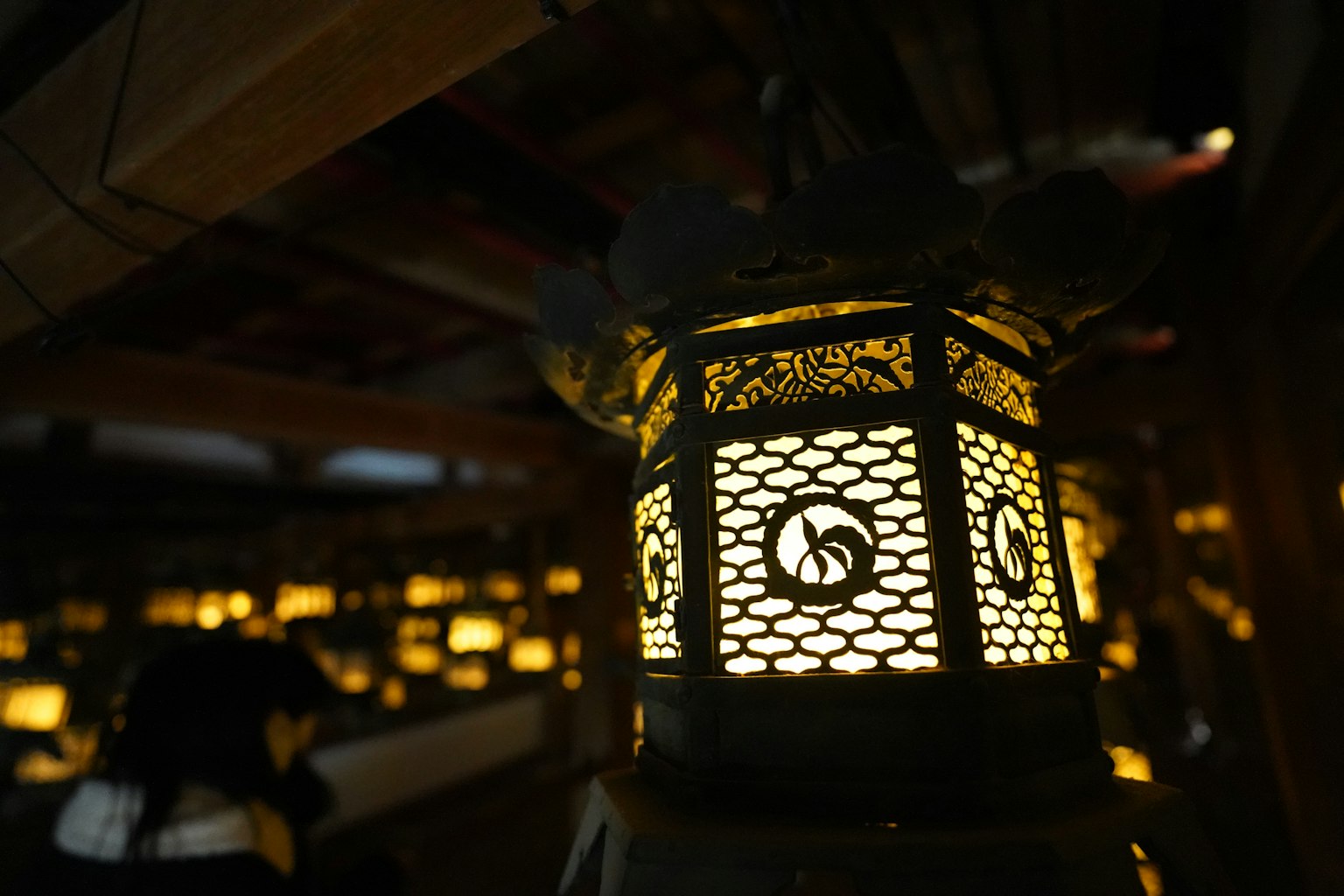 A beautiful Japanese lantern casting light in a dark background