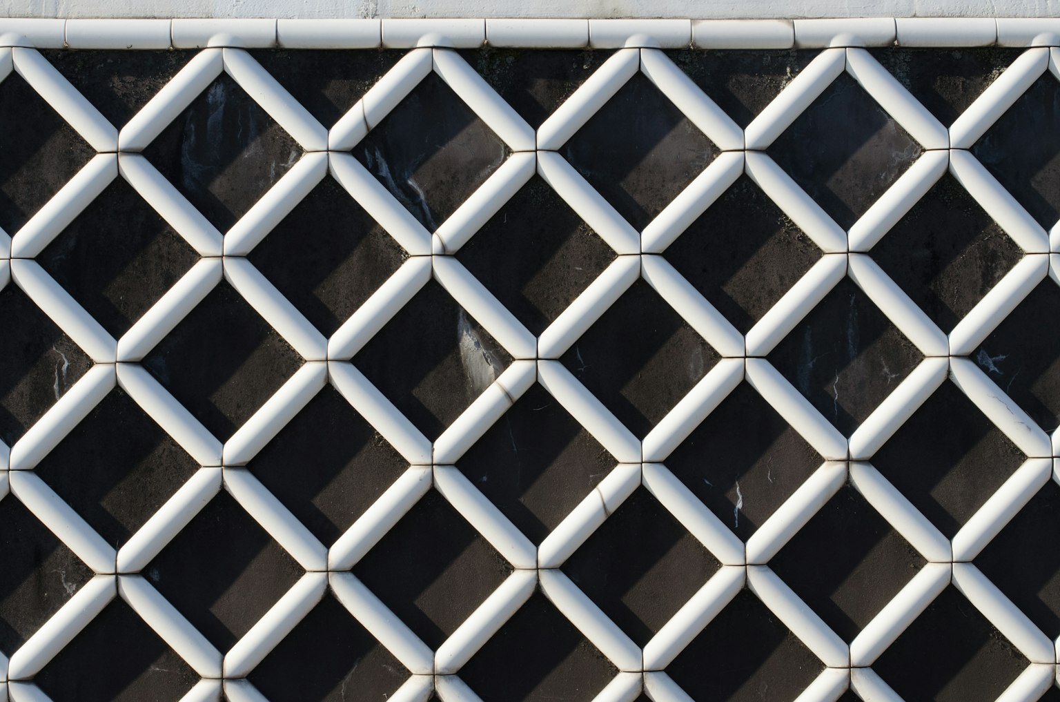 Building facade featuring a pattern of white diamond shapes against a black background