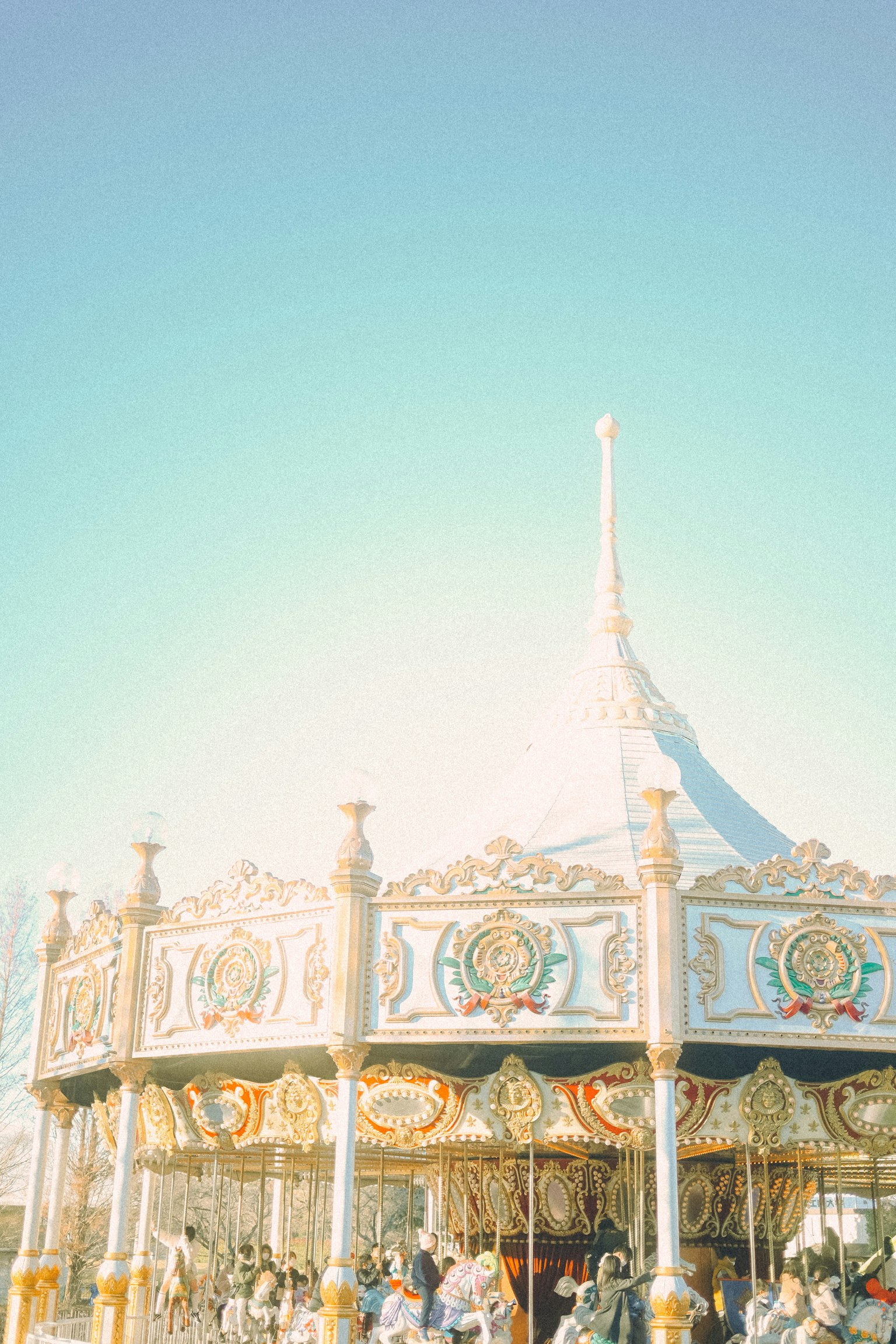 Colorful carousel under bright blue sky with intricate designs