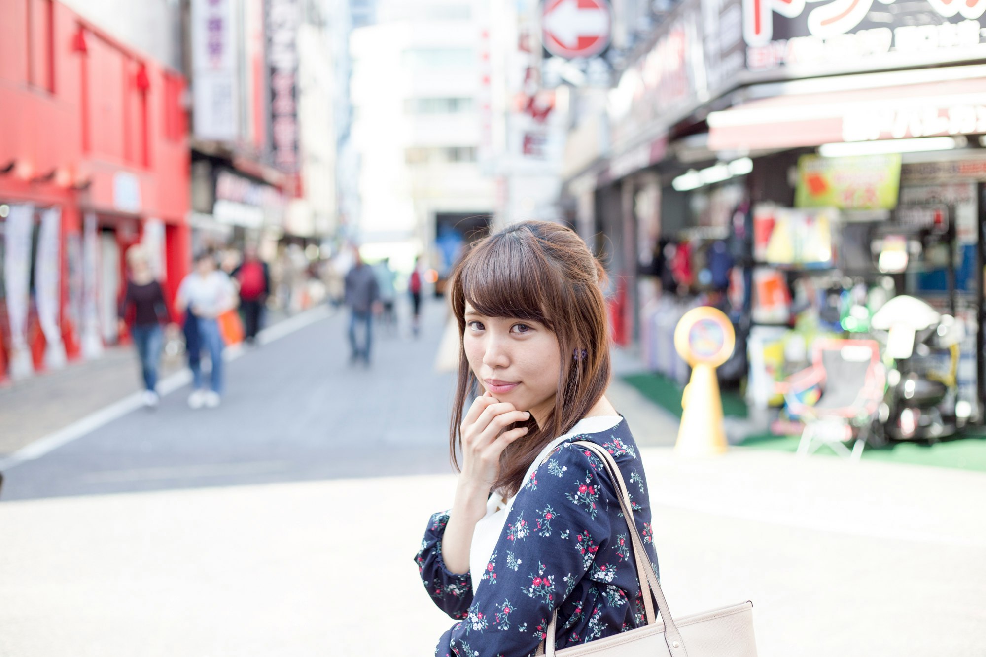 woman holding shopping bags in a shopping street