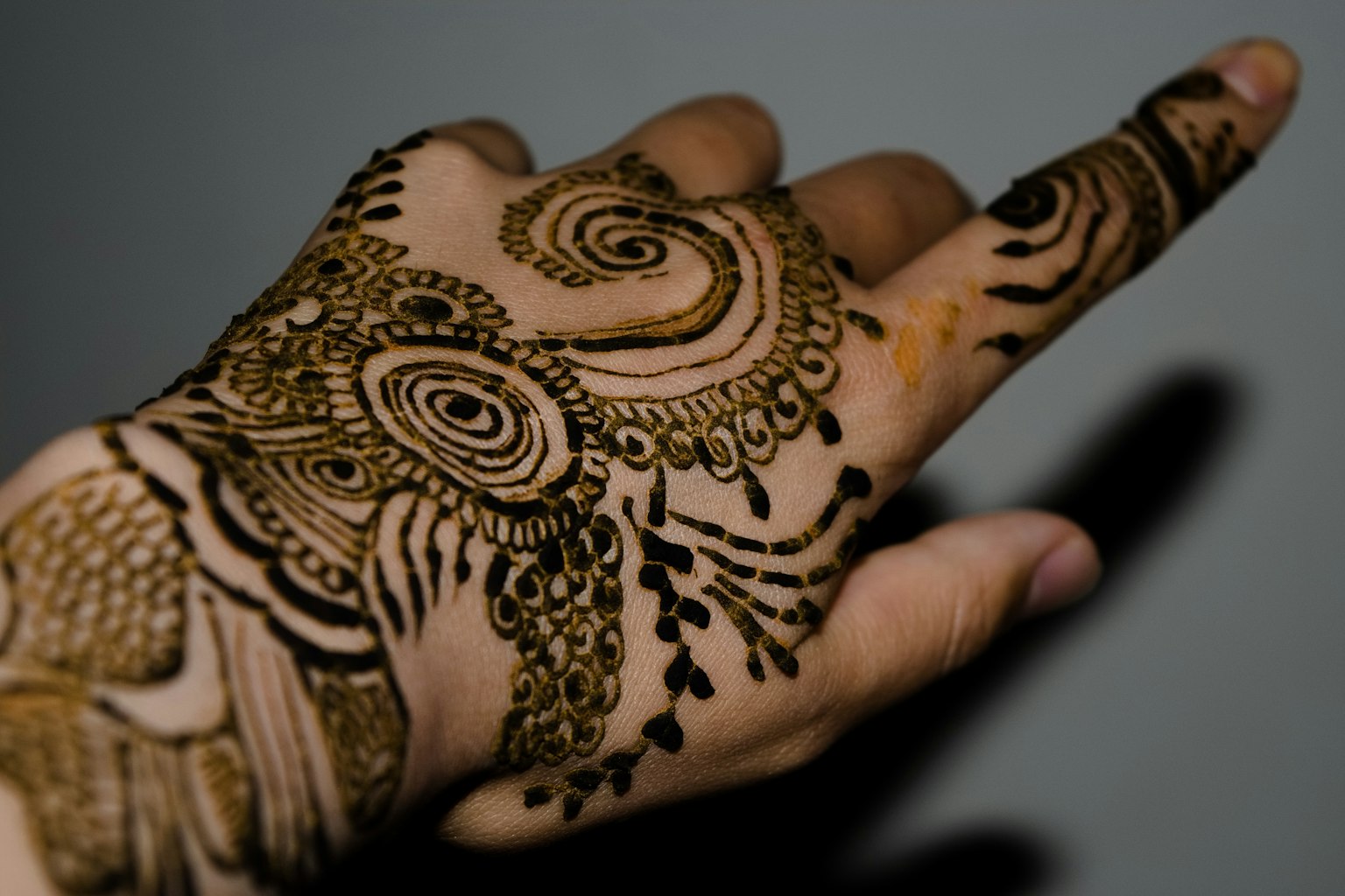 Hand adorned with intricate henna art design