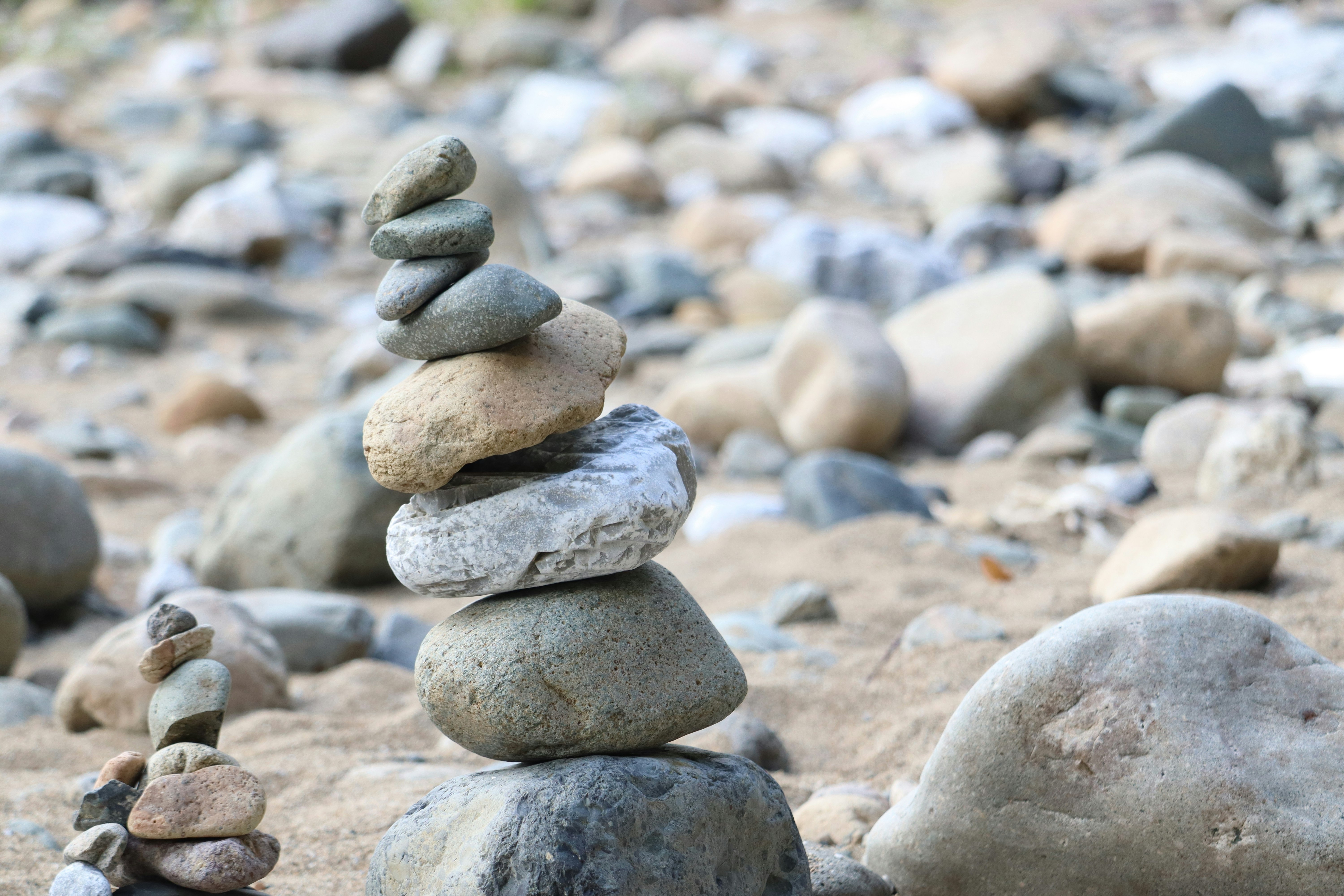 stone cairn and stacked rocks on a riverbank