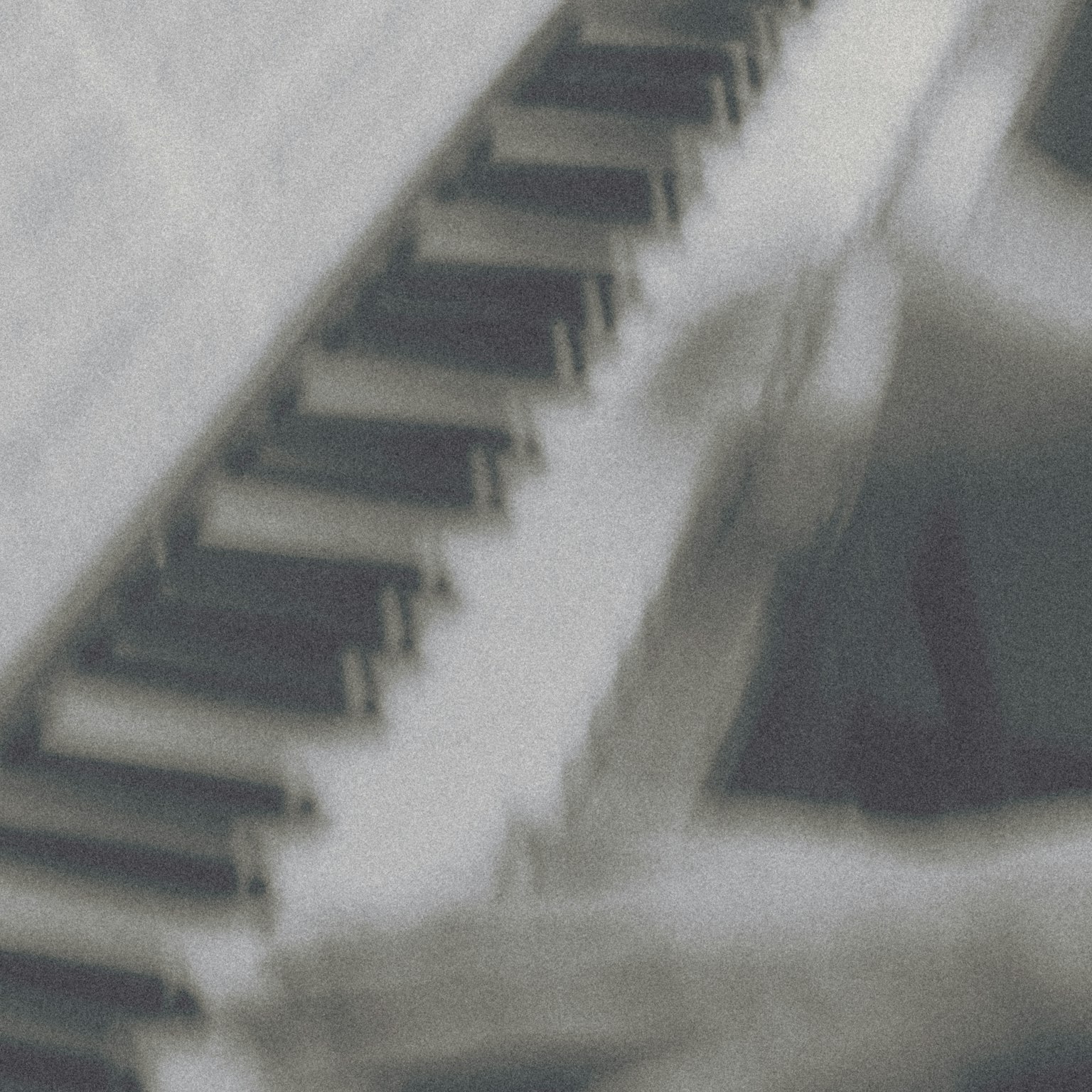 Blurred image of piano keys with hands playing