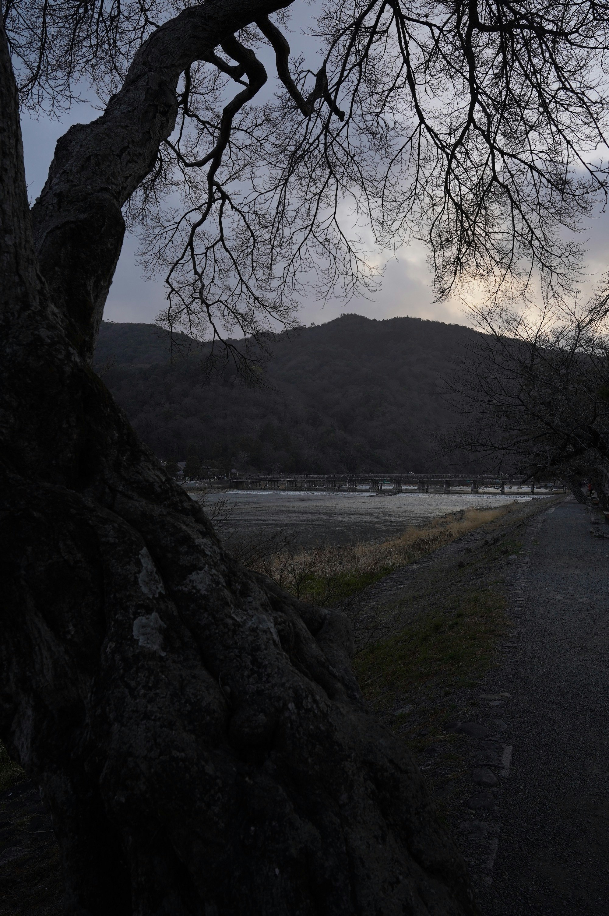 Arashiyama and Togetsukyo Bridge at a quiet dusk riverside scene