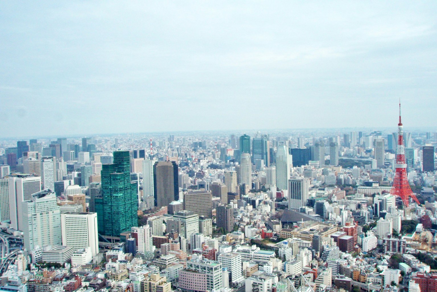 Panoramic view of Tokyo skyline featuring skyscrapers and Tokyo Tower