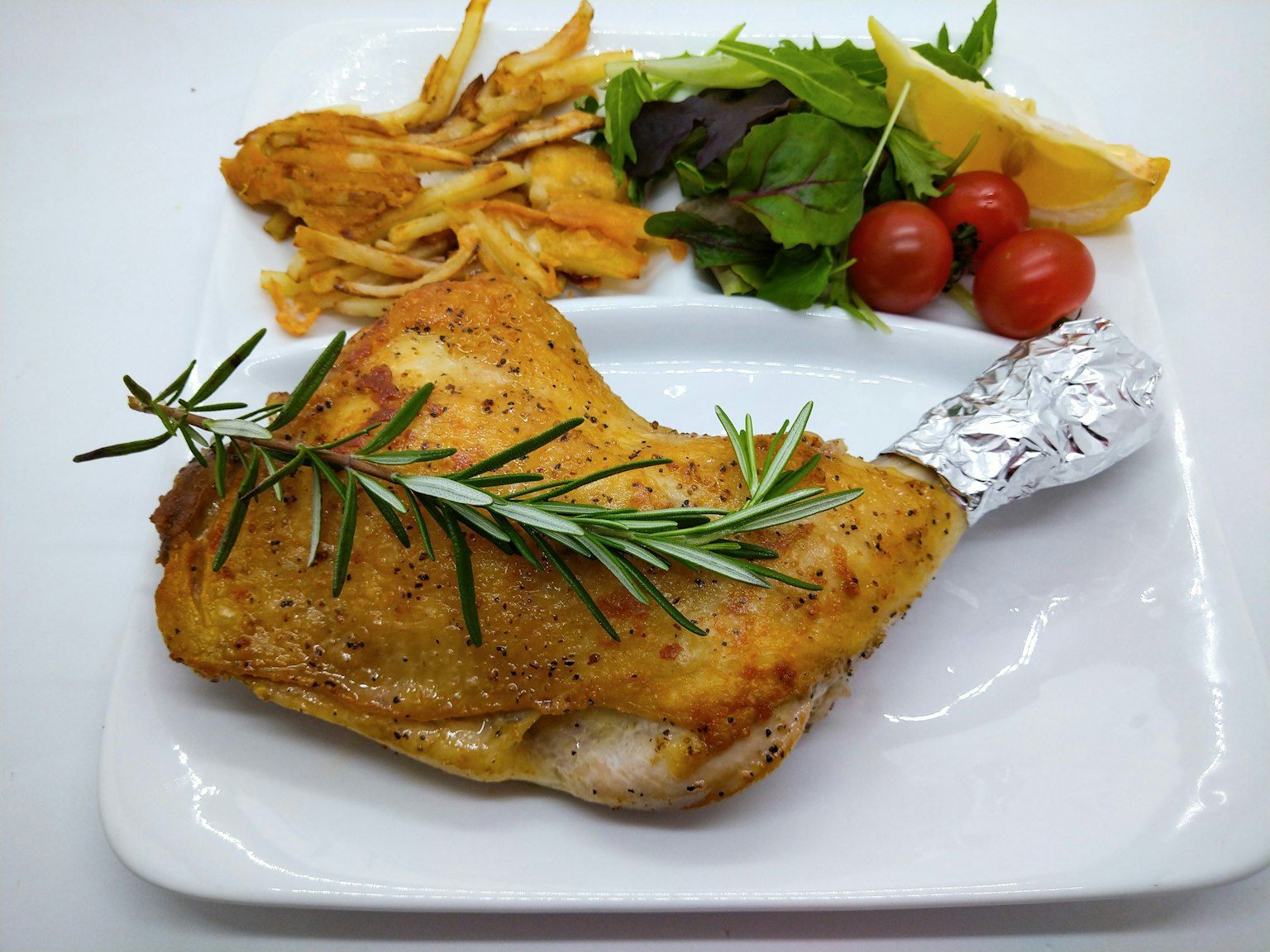 จานไก่อร่อยตกแต่งด้วยโรสแมรี่เสิร์ฟพร้อมผัก