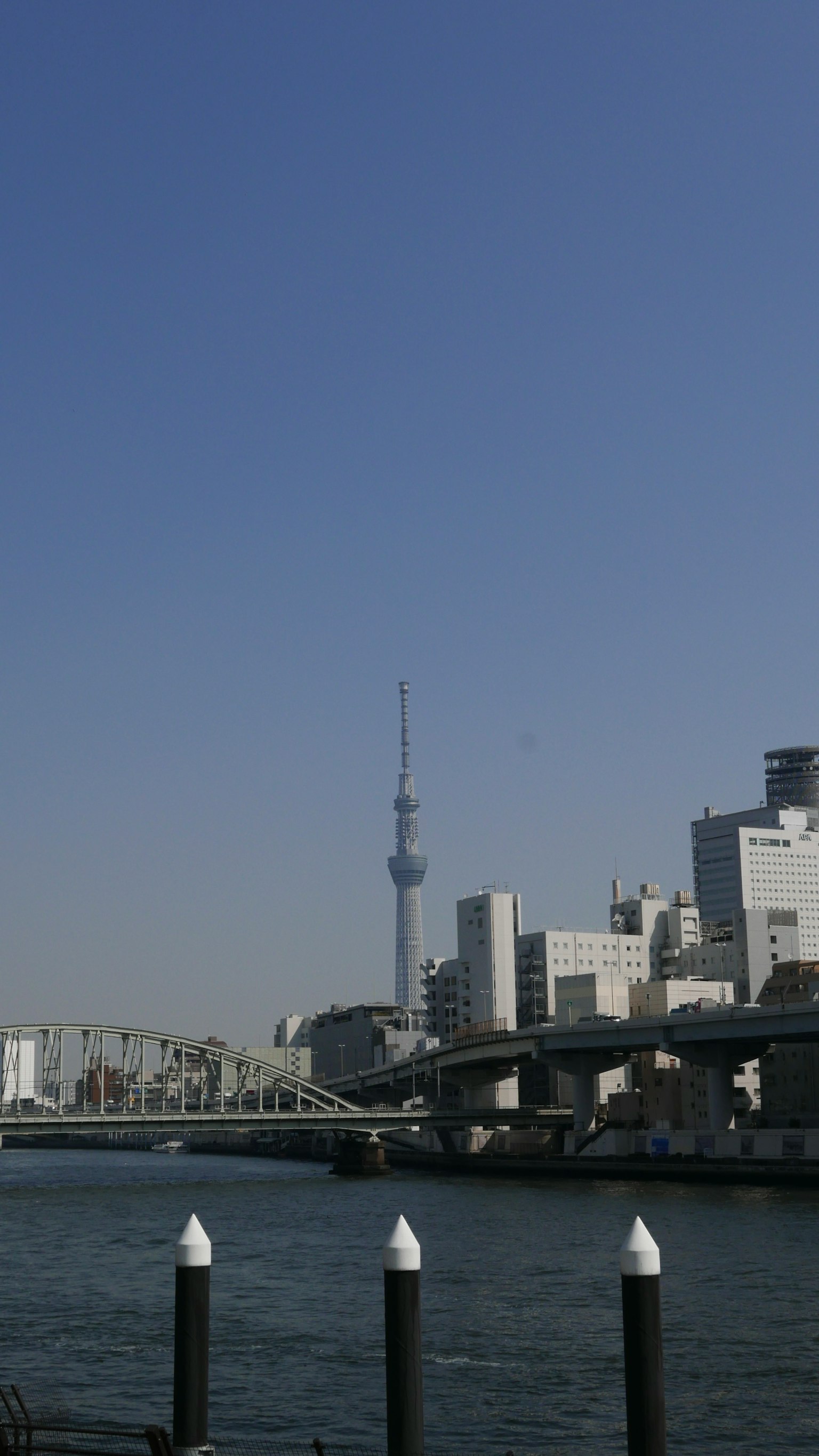 Tokyo Skytree dan pemandangan tepi sungai langit biru cerah dan gedung pencakar langit