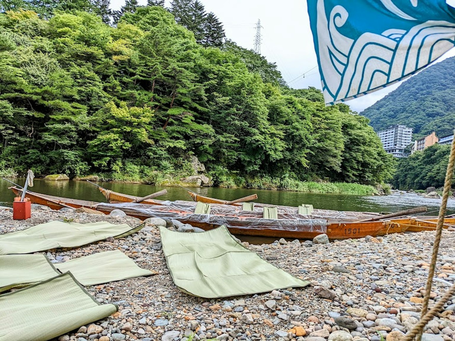 Wooden boats by the riverbank with lush green forest