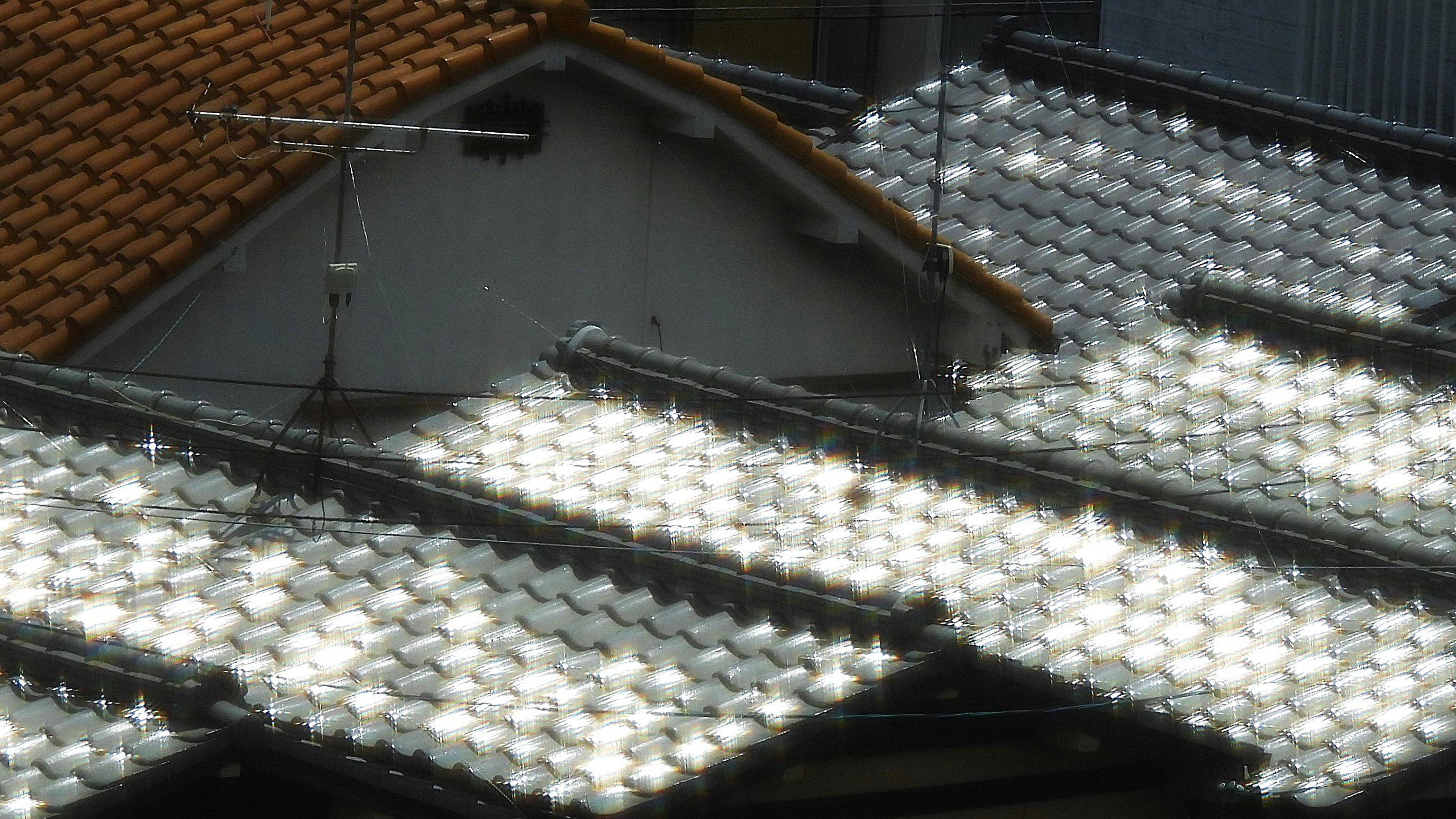 甍の波のように連なる屋根の窓景色