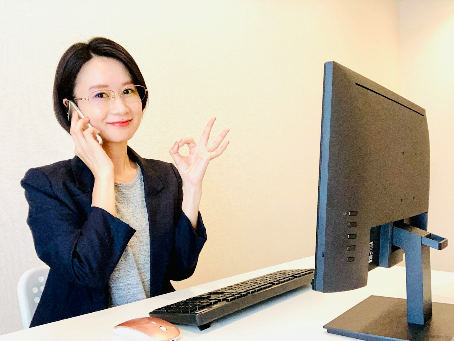 Wanita bisnis tersenyum memberikan jempol sambil berbicara di telepon
