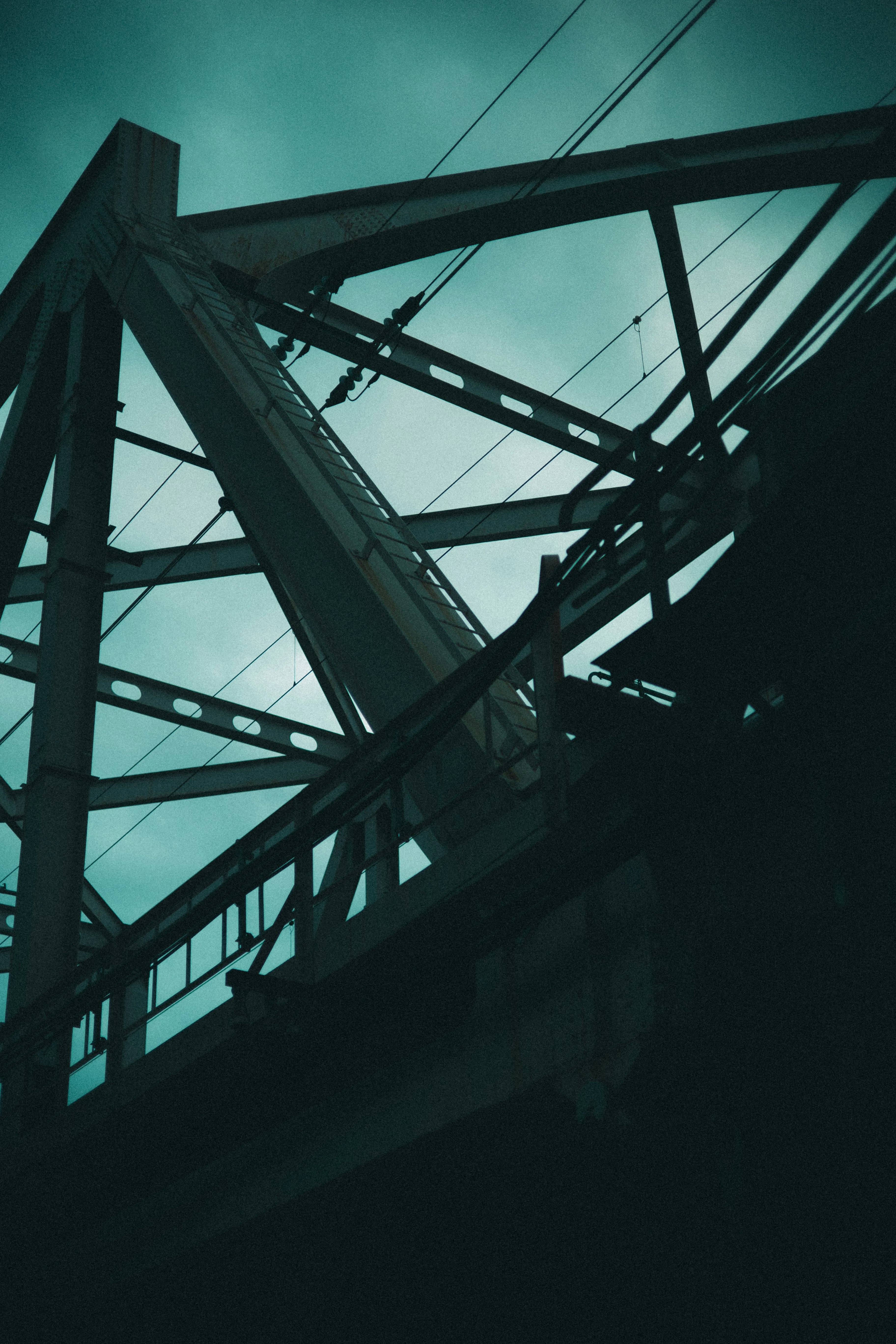 steel truss bridge structure against blue sky