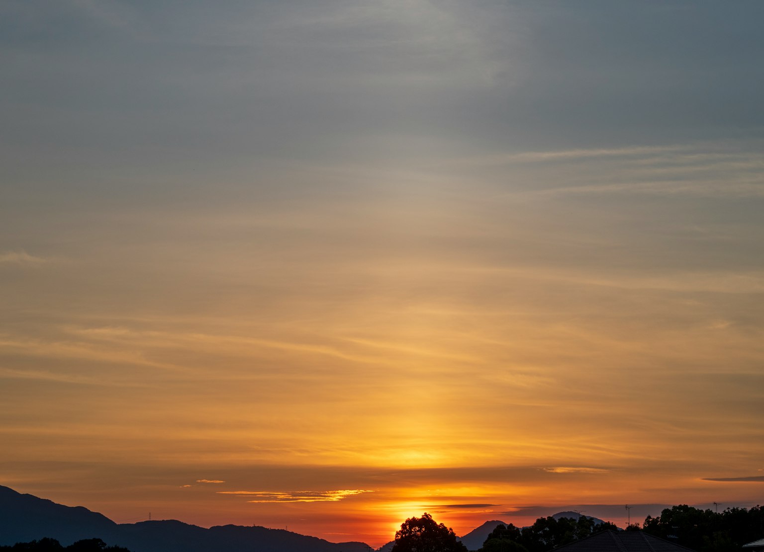 Hermoso paisaje de un atardecer con degradados de naranja y azul en el cielo