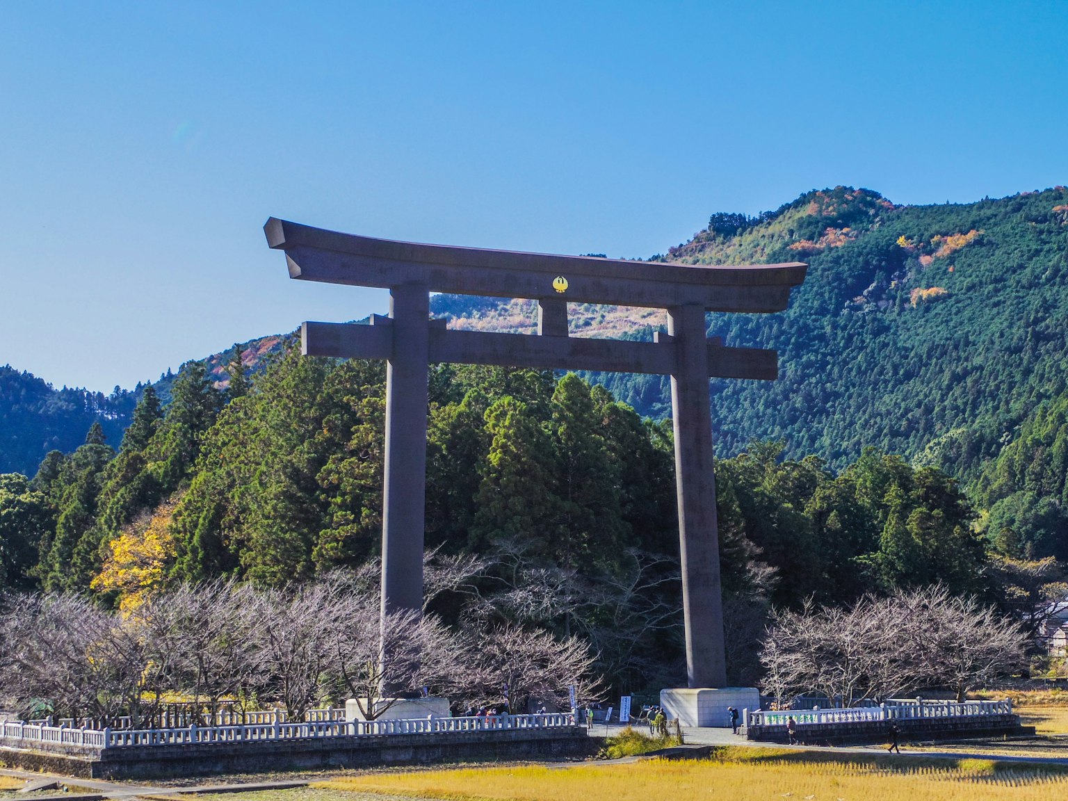 Großer Torii unter einem klaren blauen Himmel mit umliegenden Bergen