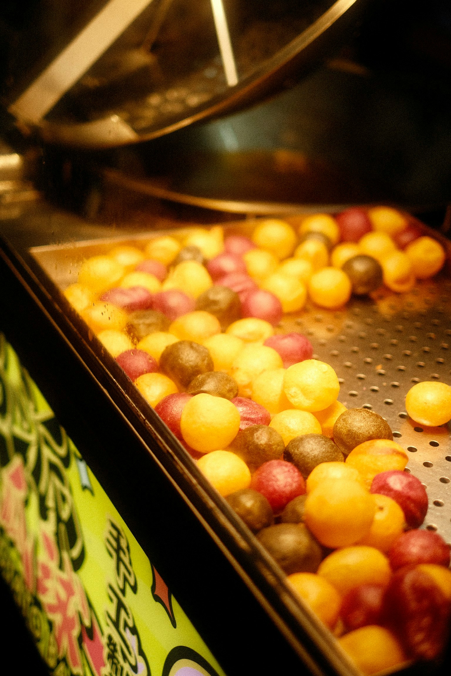 Colorful ball-shaped sweets in a display case at a Taiwanese street stall