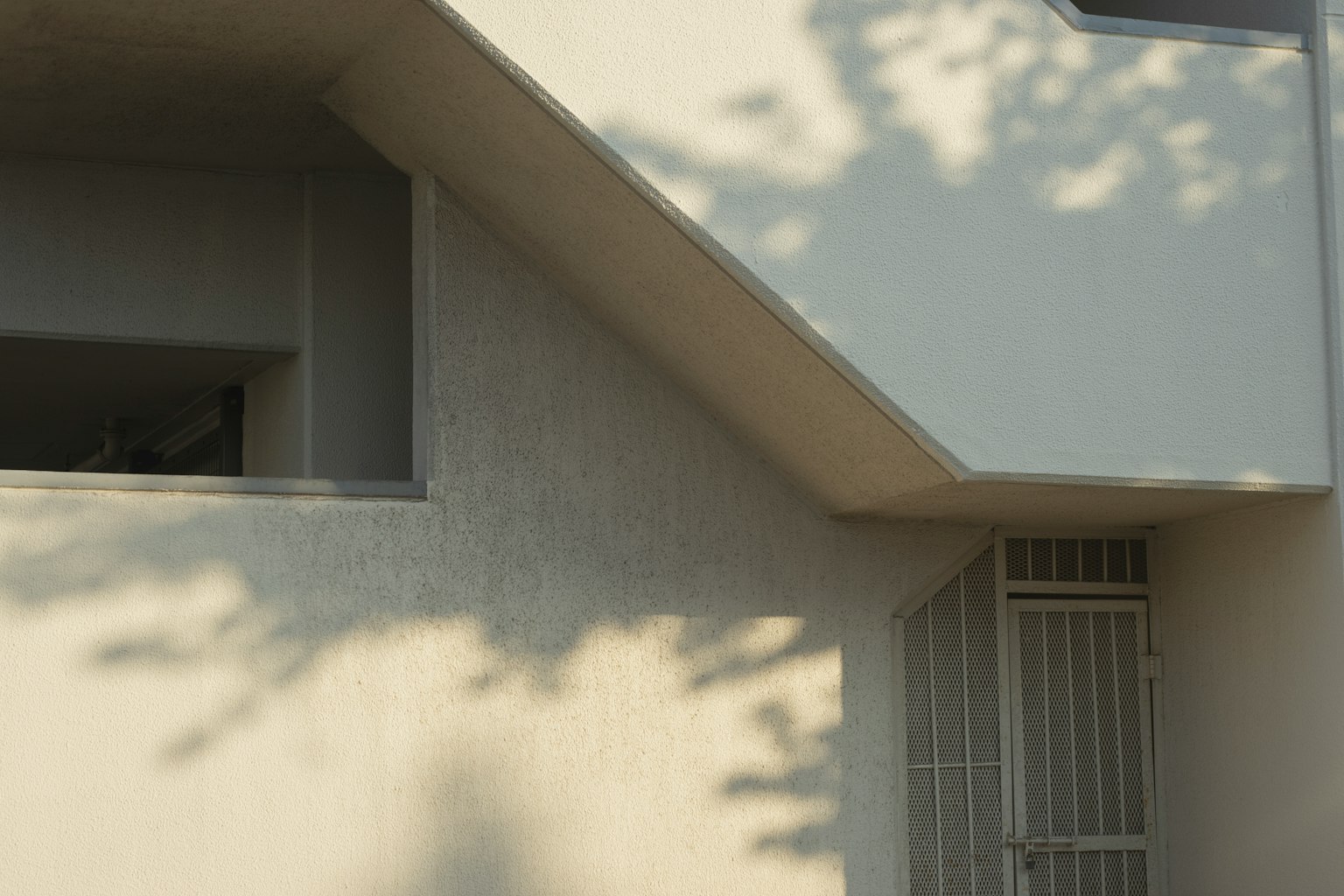 Modern building section with white wall and shadow patterns