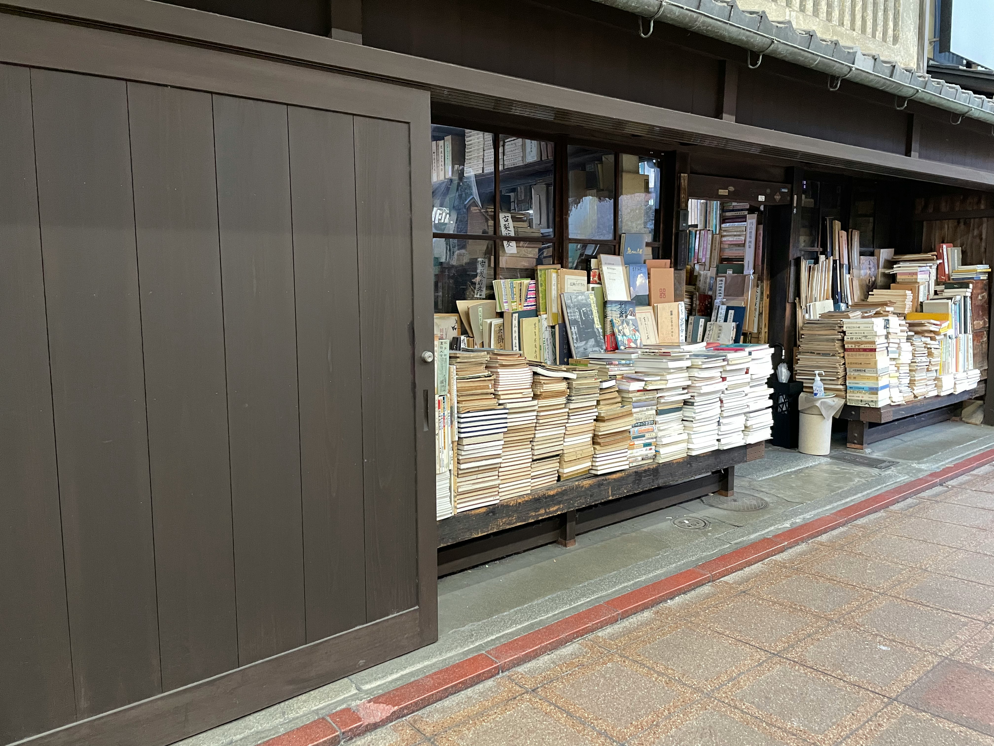 books stacked on display shelves at a storefront