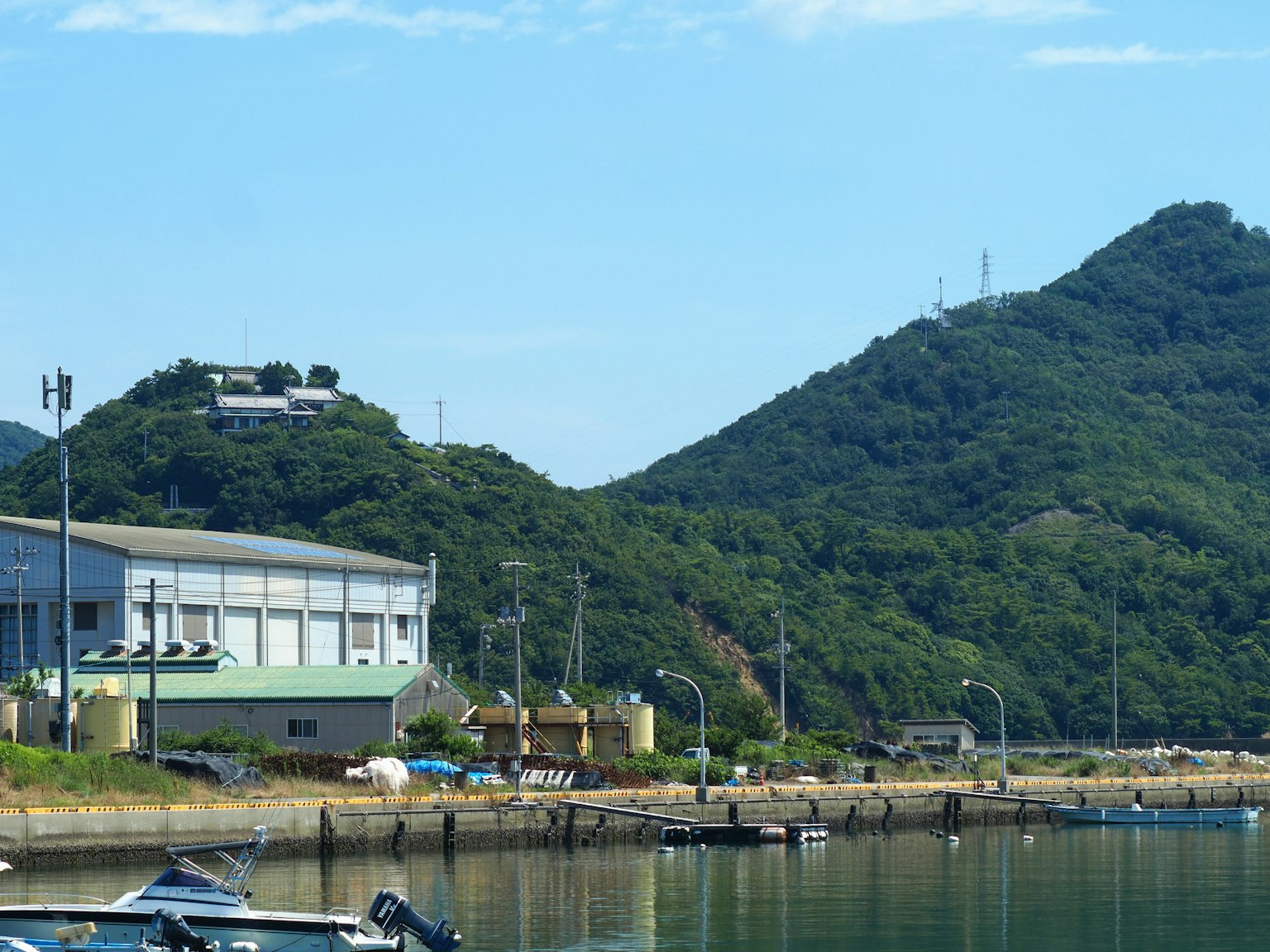 항구 옆 공장과 푸른 언덕의 경치