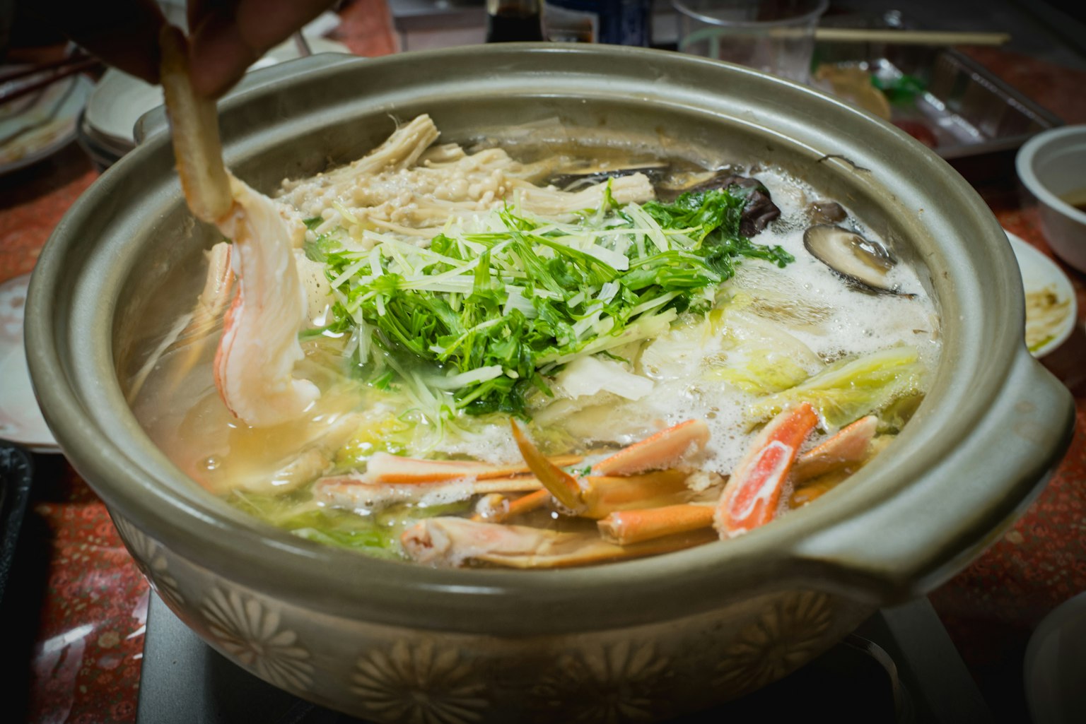 Delicious hot pot filled with fresh vegetables and seafood in a savory broth